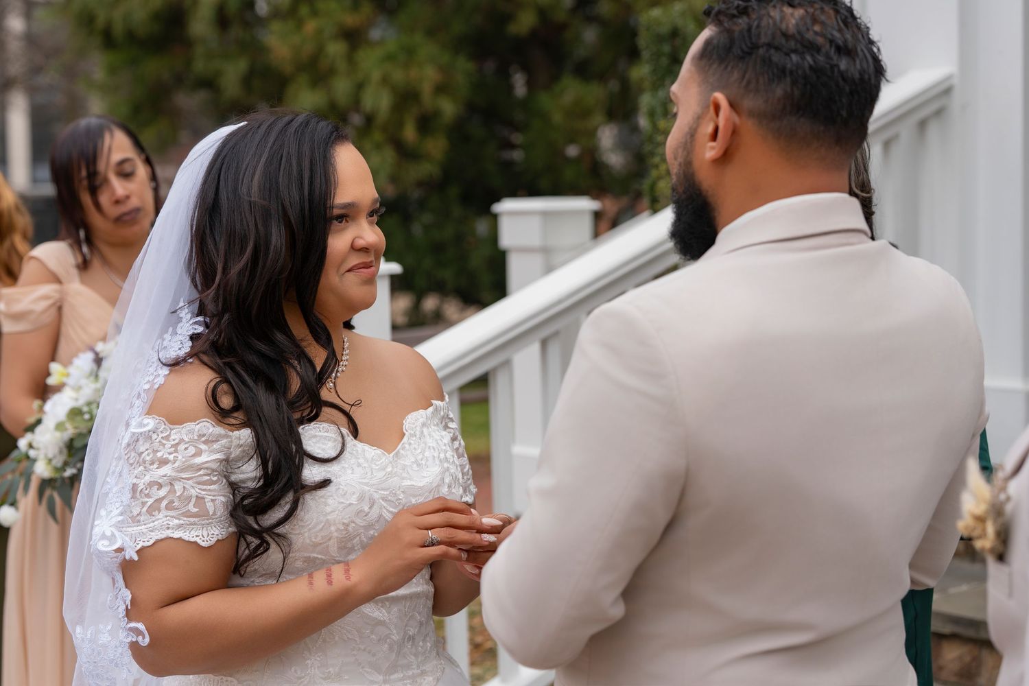A bride and groom share a romantic moment during their wedding celebration in a garden setting.