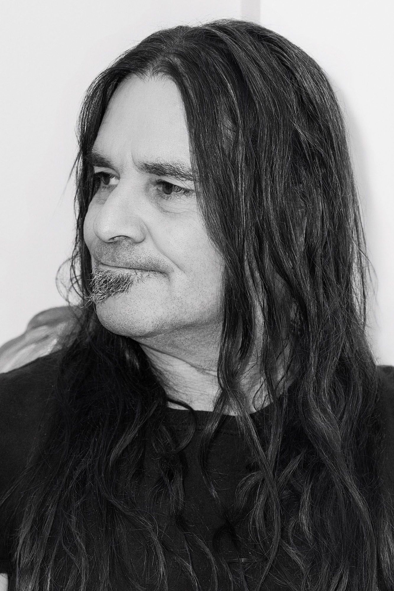 Black and white portrait series showing different angles of a figure with long dark hair in a dark shirt.