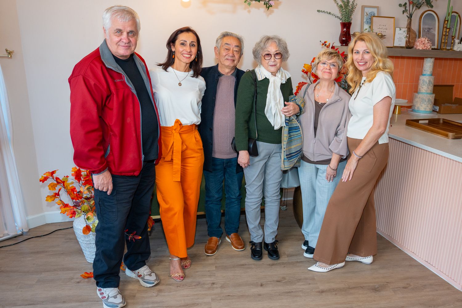 Group photo of event attendees standing together in a restaurant interior.