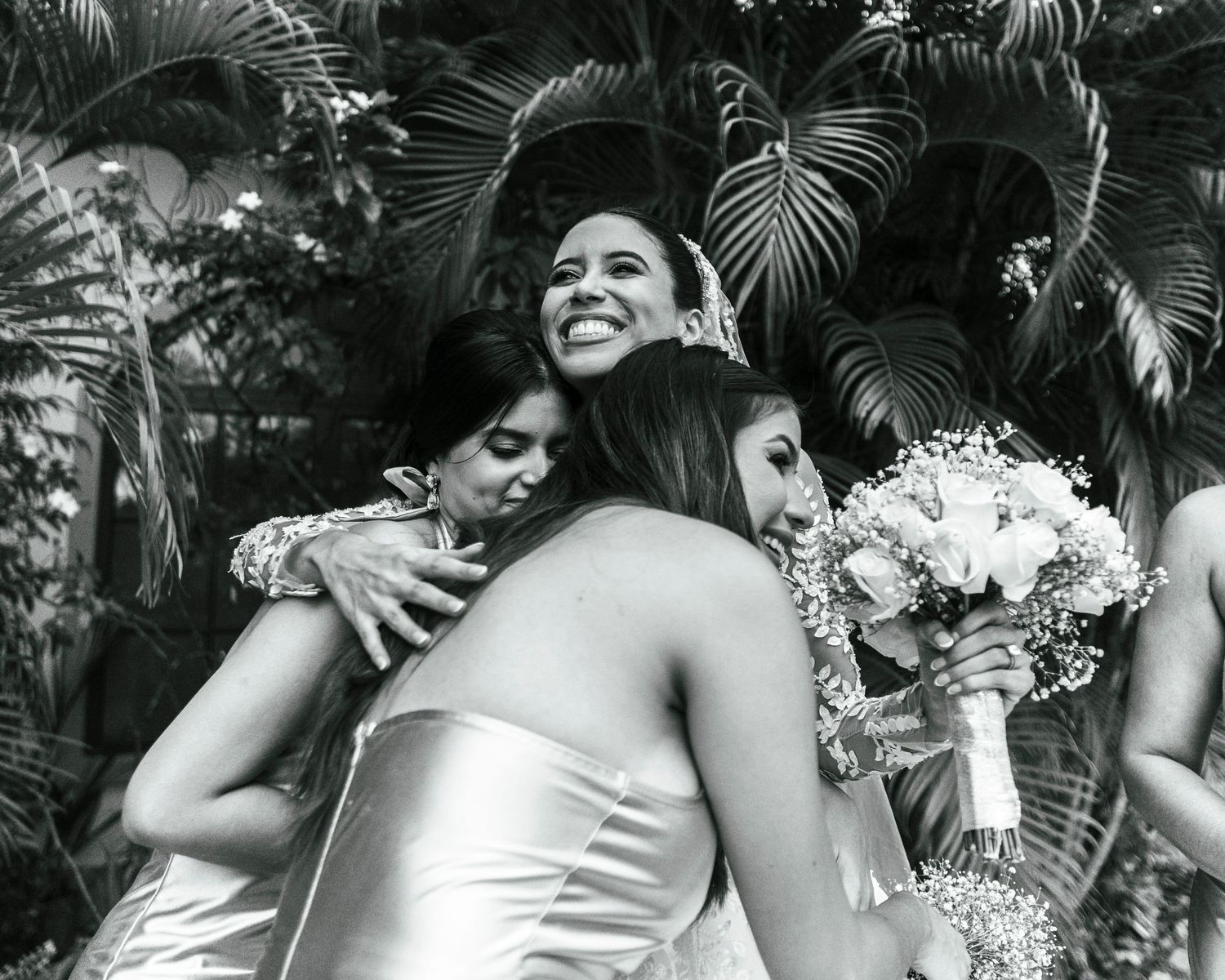 Black and white wedding photo sequence capturing joyful moments between wedding party members.