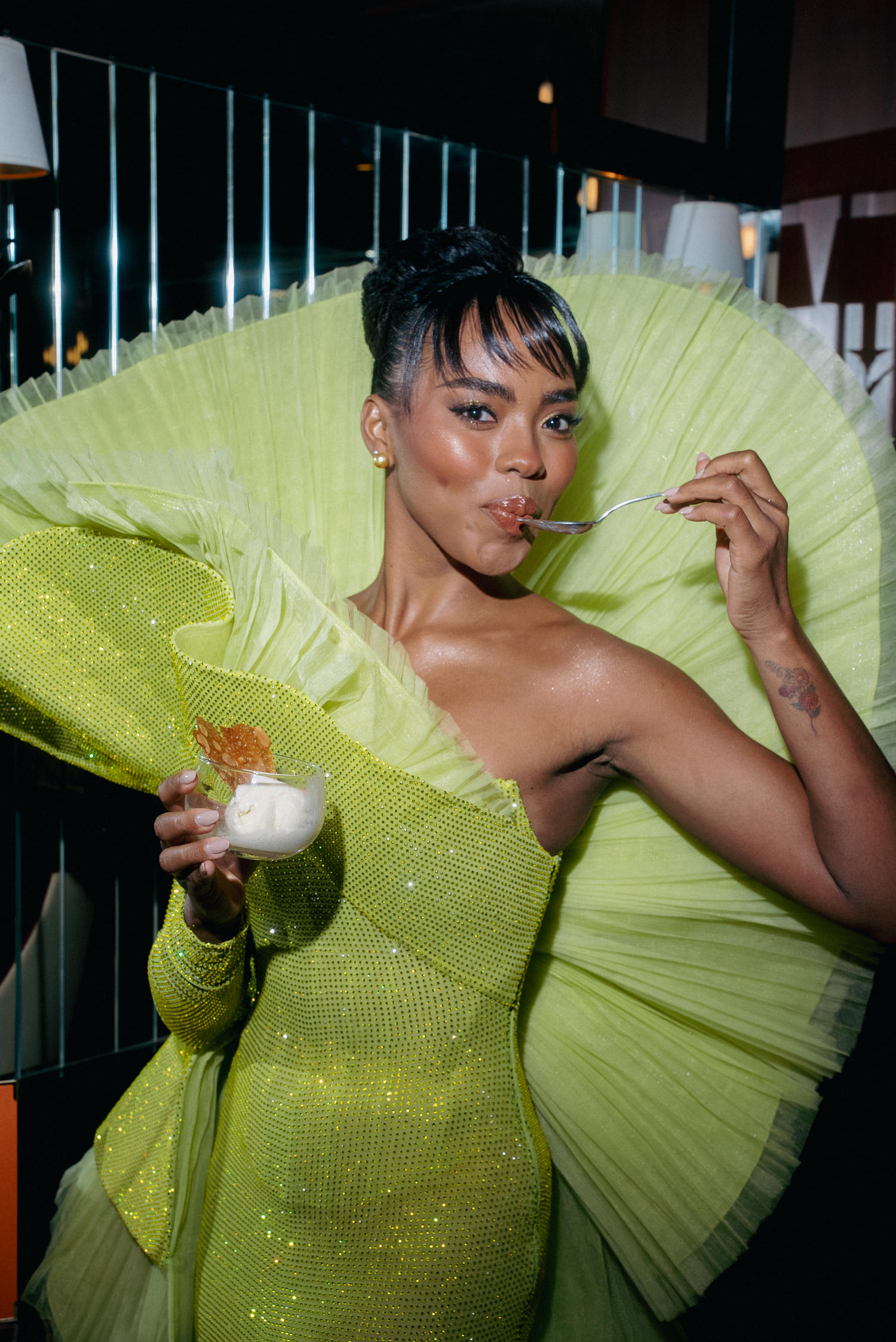 Dynamic poses in a neon yellow ruffled gown captured in dramatic lighting.