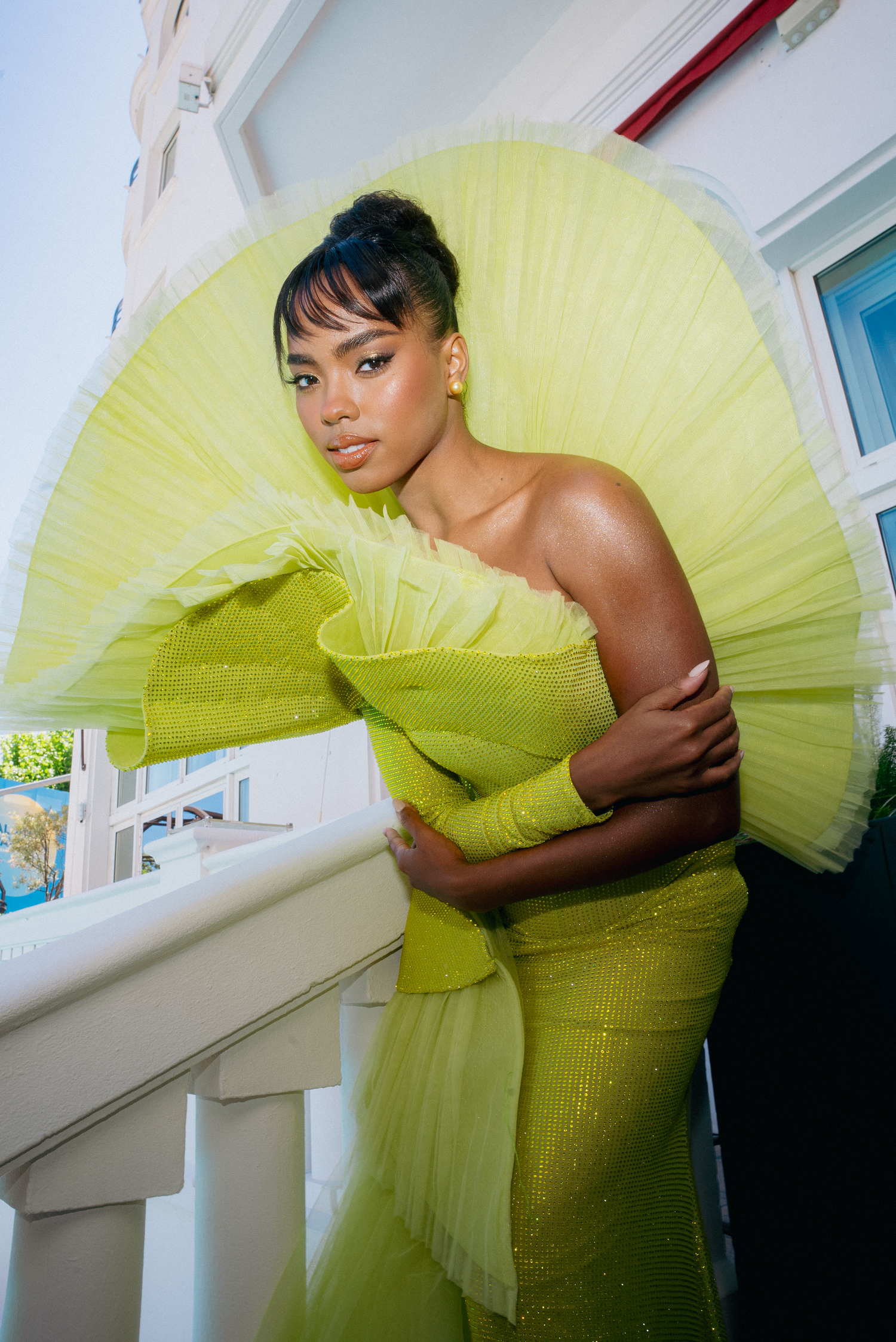 Artistic fashion photos showcasing a structured neon yellow dress indoors.