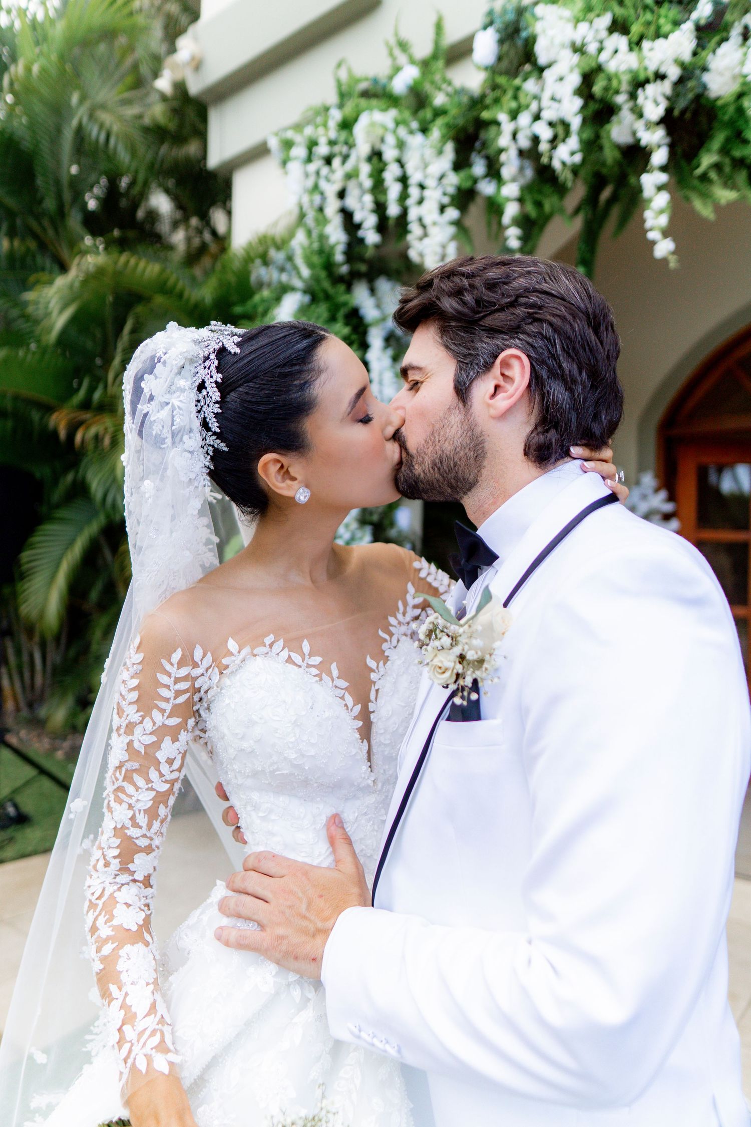 A romantic wedding photo series showing tender kisses between newlyweds in a garden setting.