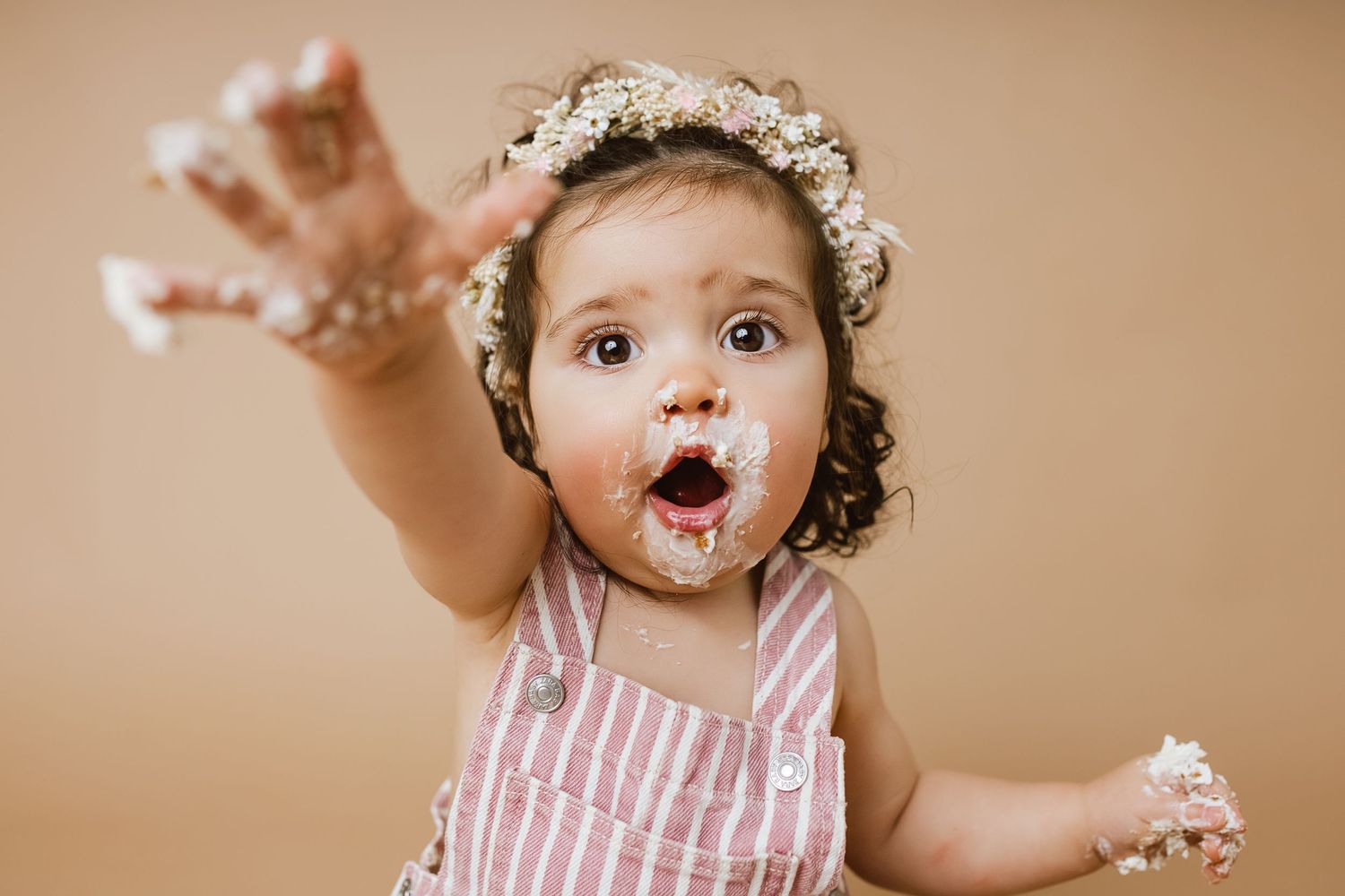 A series of playful expressions and poses captured in a warm-toned studio portrait session with a small child.