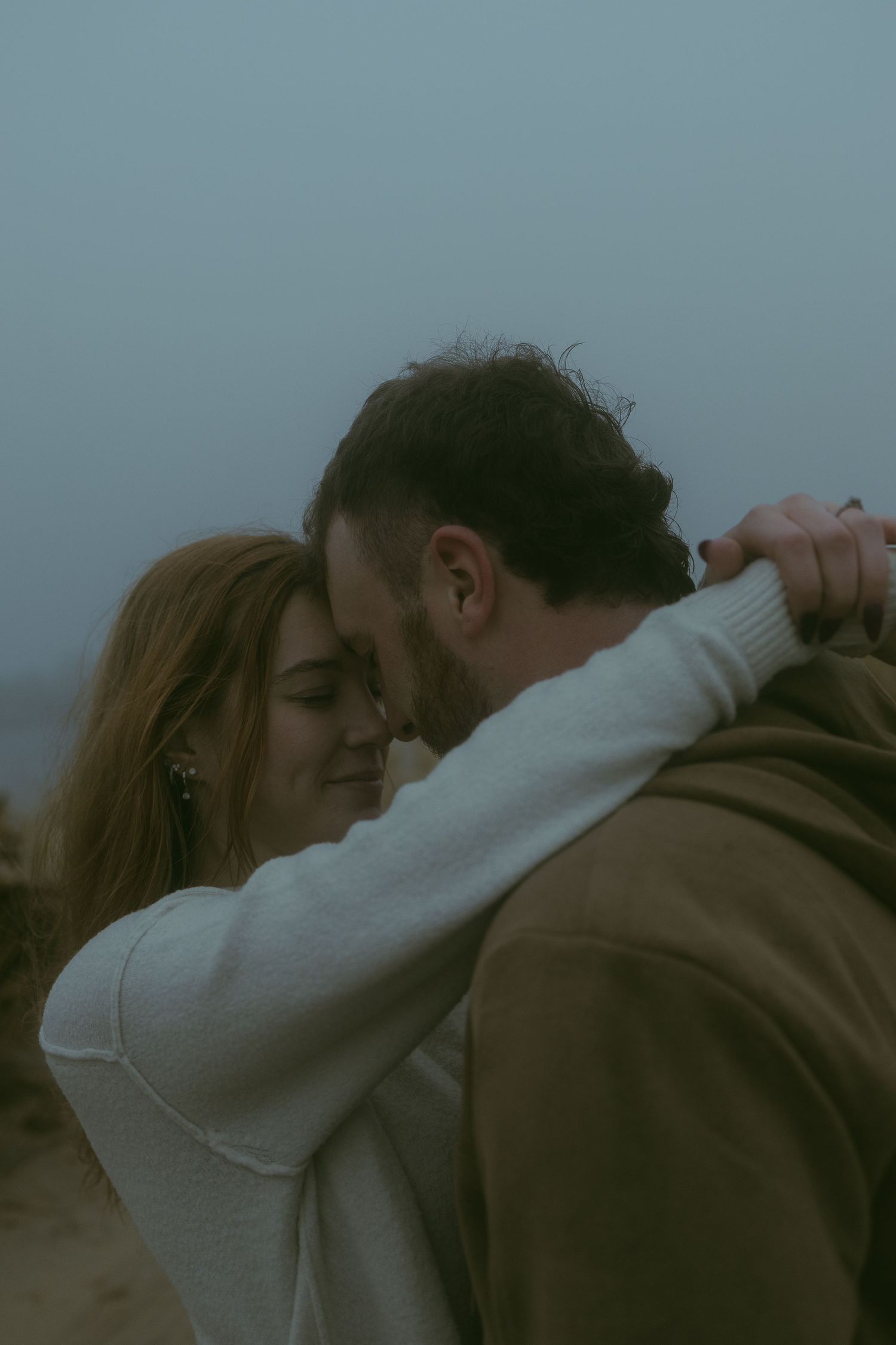 Tender moments shared between two people on an overcast day.