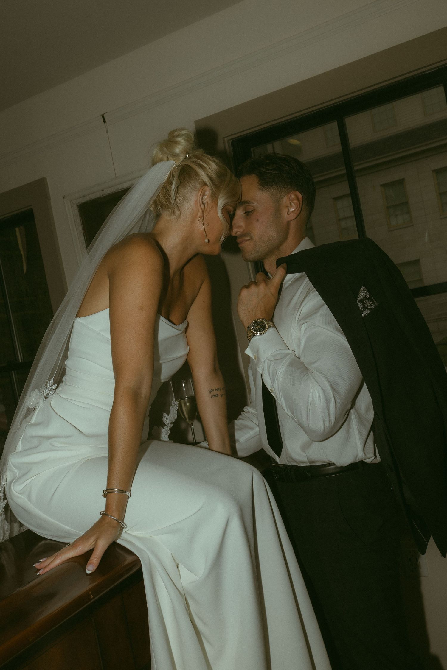An intimate wedding reception moment captured in vintage-style photography.