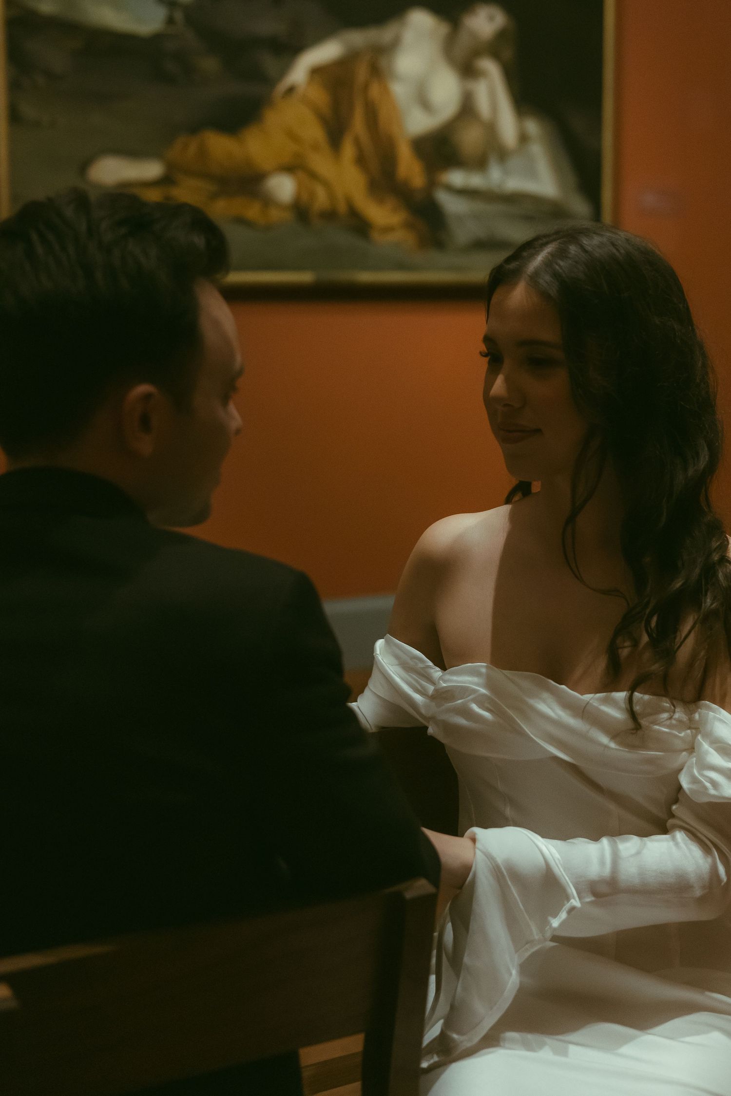 Couple dancing together in an intimate indoor setting with warm lighting.