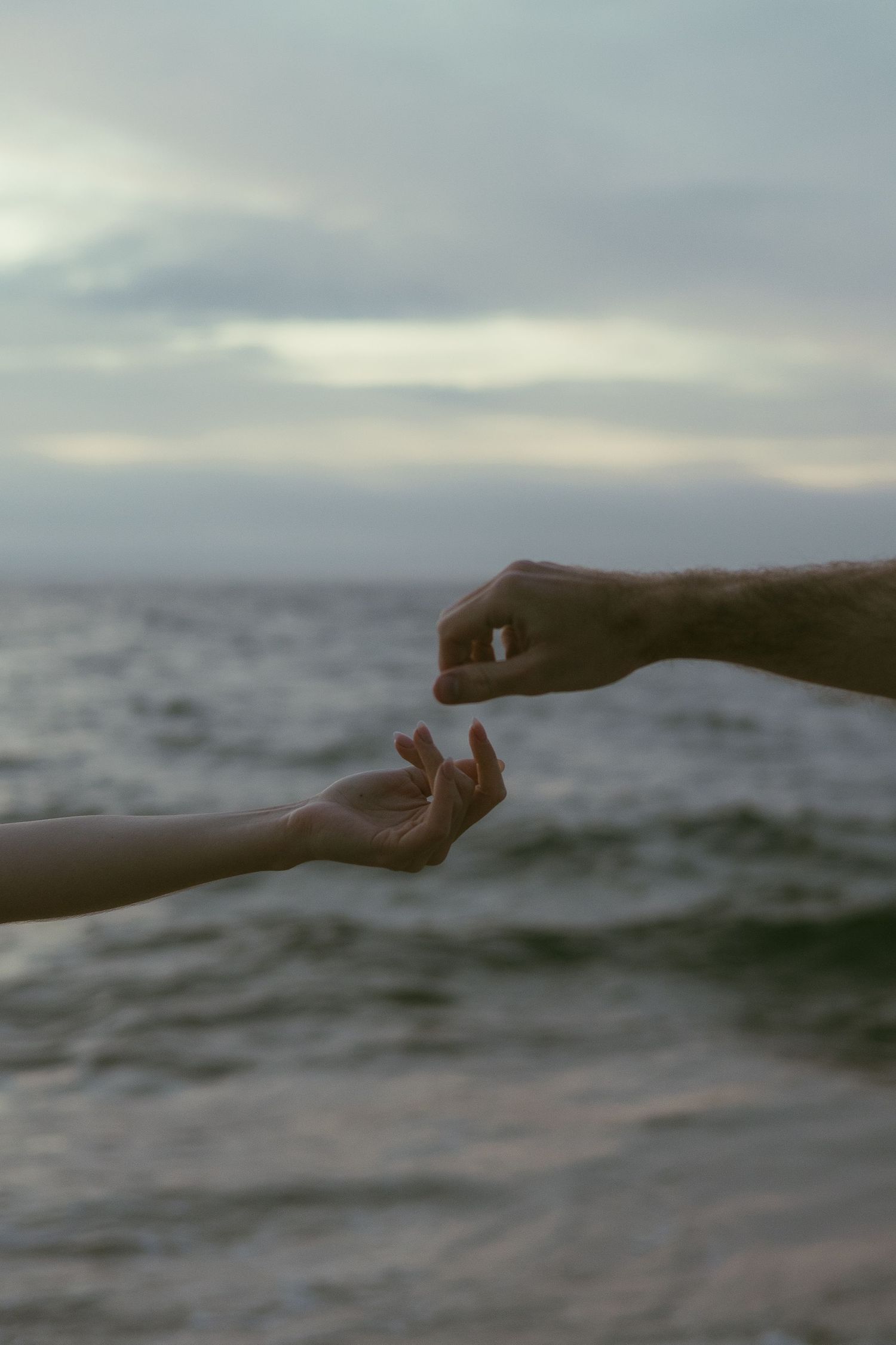 Hand silhouettes against an ocean horizon in sequential shots.