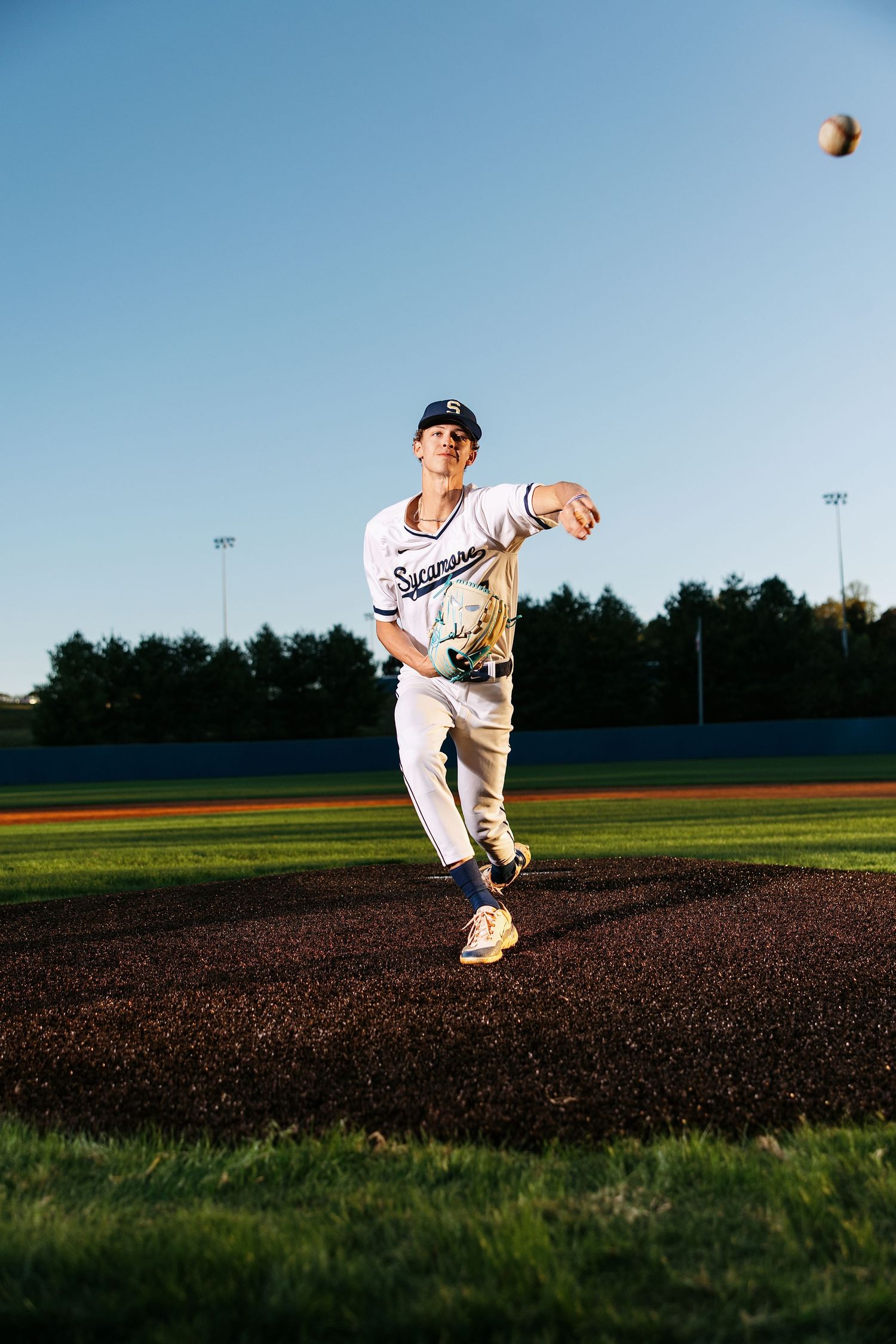 A baseball player in white uniform follows through on a pitching motion across multiple action sequence frames.