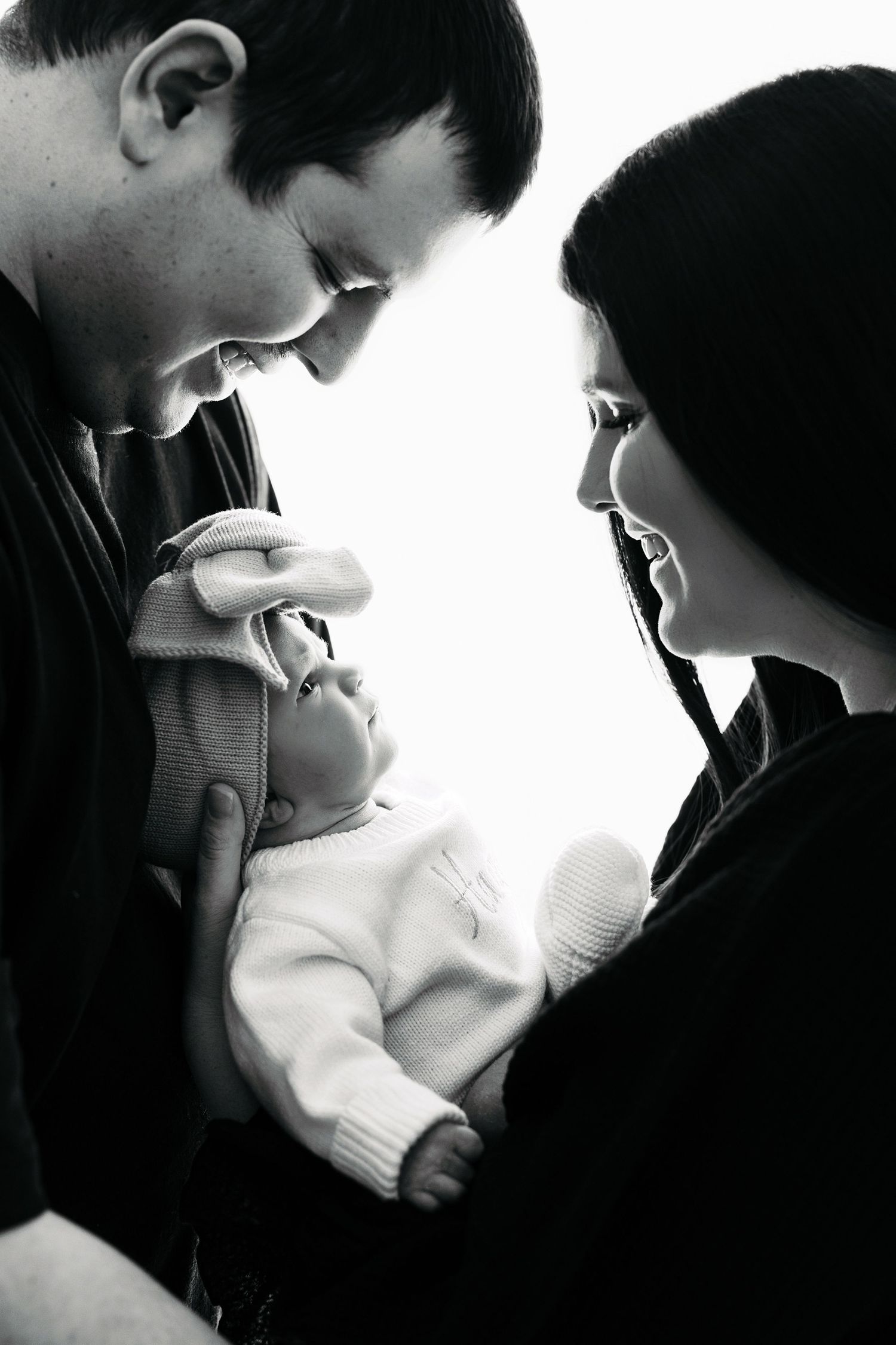 A series of intimate black and white photographs showing a tender romantic moment between two people in silhouette.