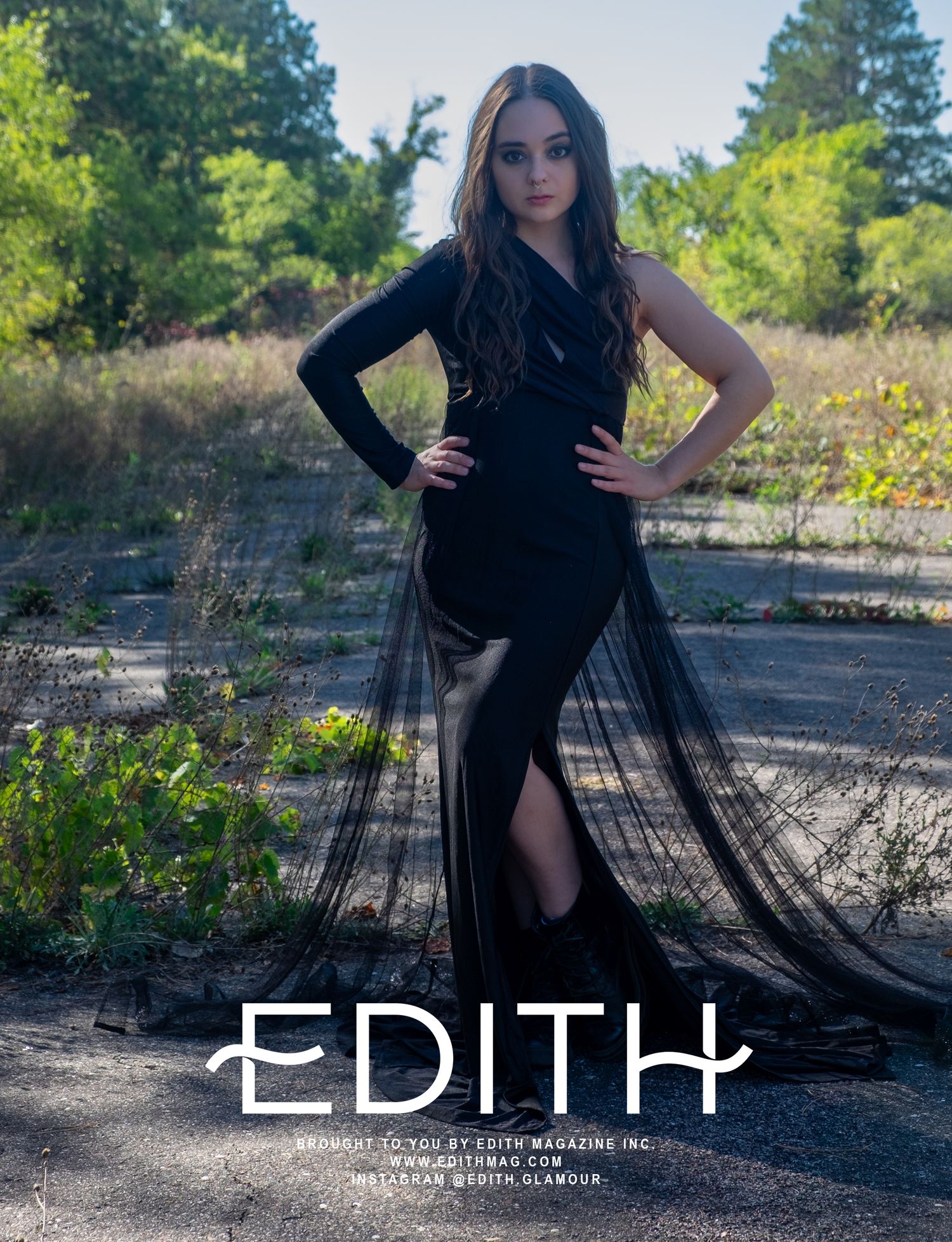 Fashion editorial featuring elegant black dress in outdoor natural setting.