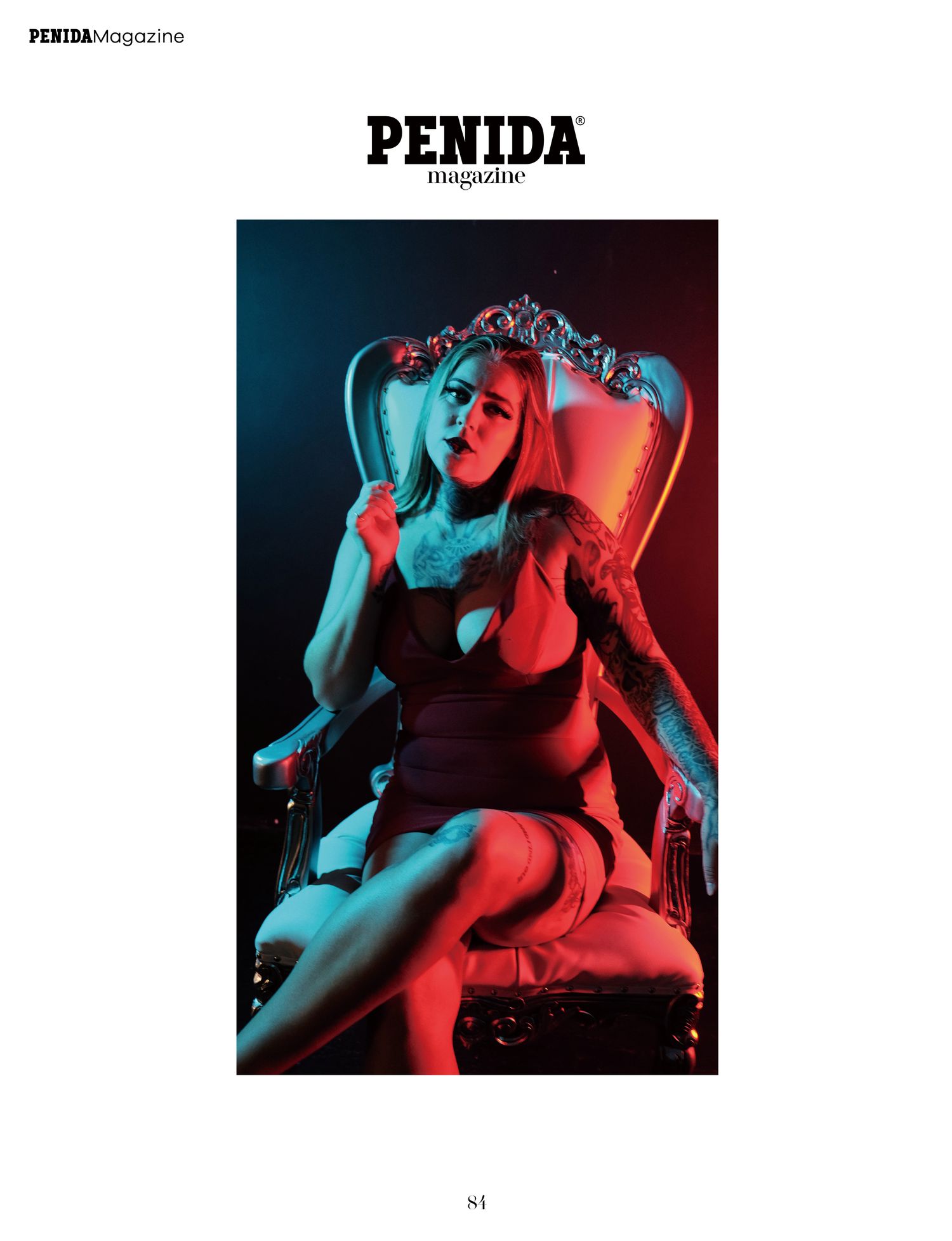 Dramatic portrait on ornate chair with neon red and blue lighting effects for Penida Magazine.