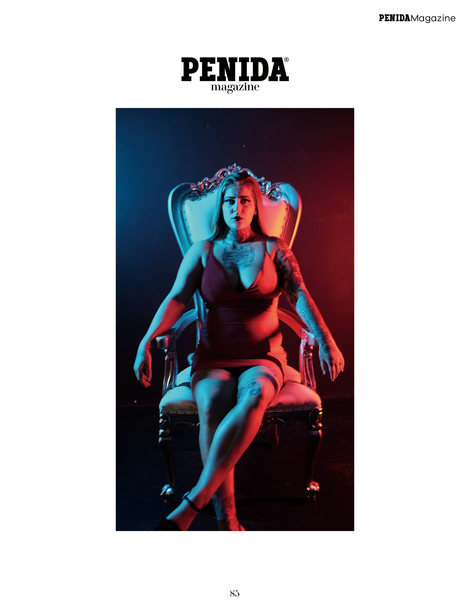 Fashion editorial featuring model seated on vintage chair with split color lighting.