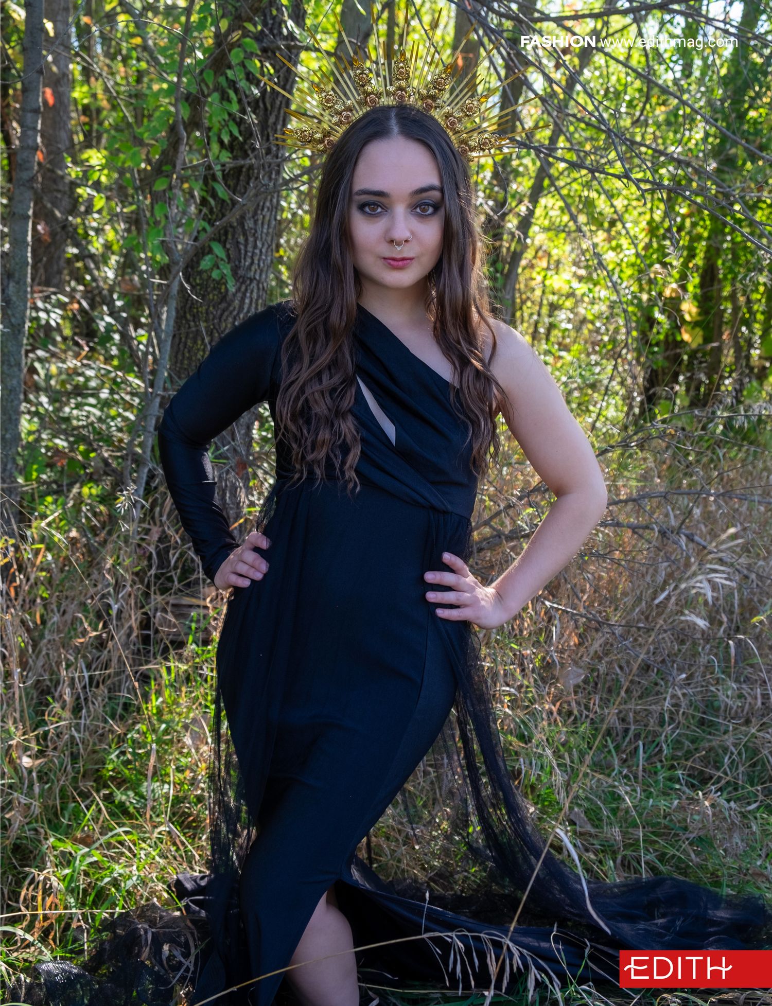 Elegant fashion portrait featuring fitted black dress in natural setting.