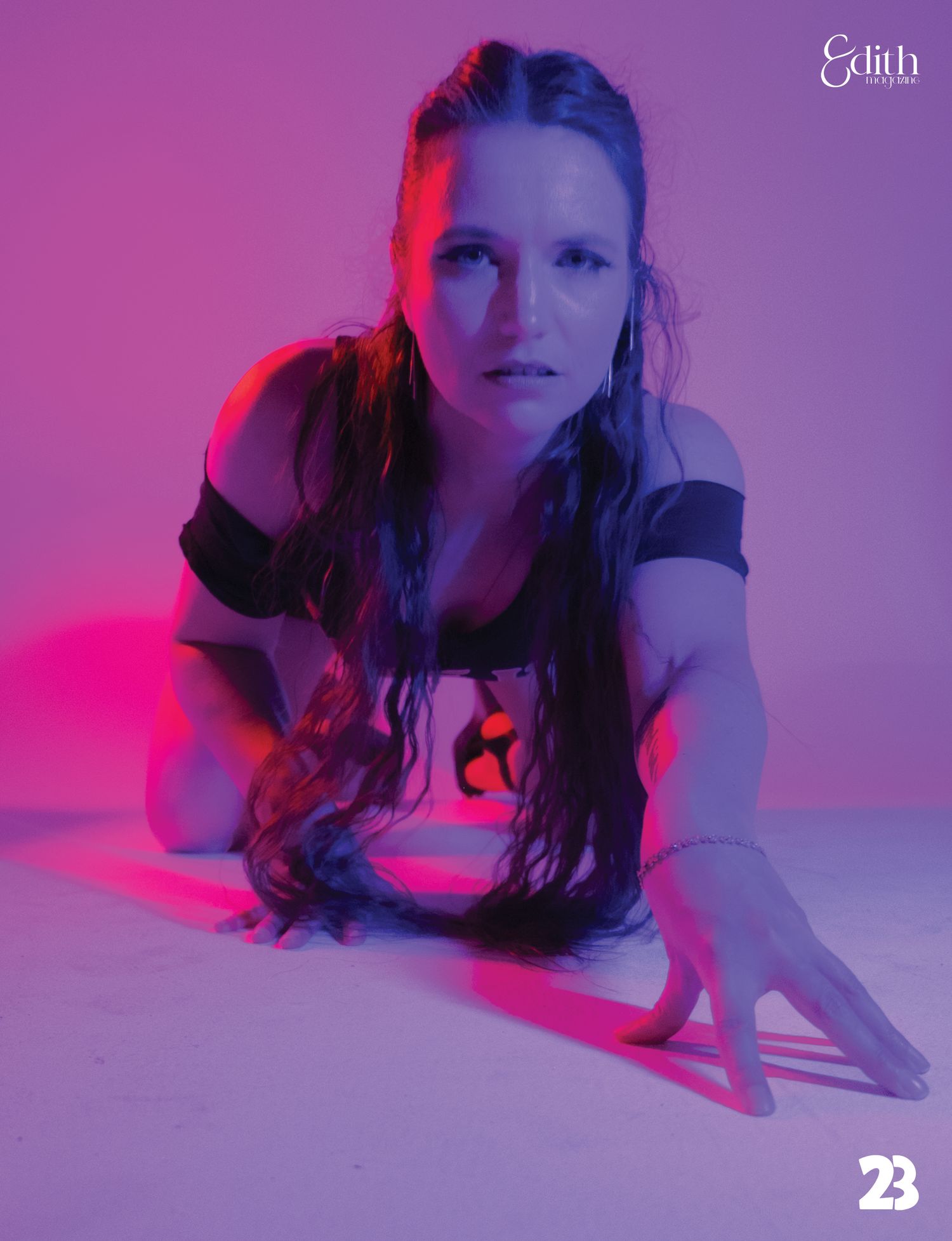 Artistic portrait with dramatic pink and purple lighting effects.