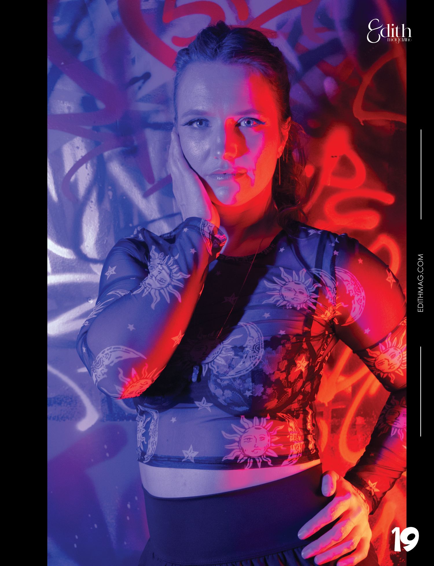 Fashion portrait with purple and red lighting featuring patterned crop top.