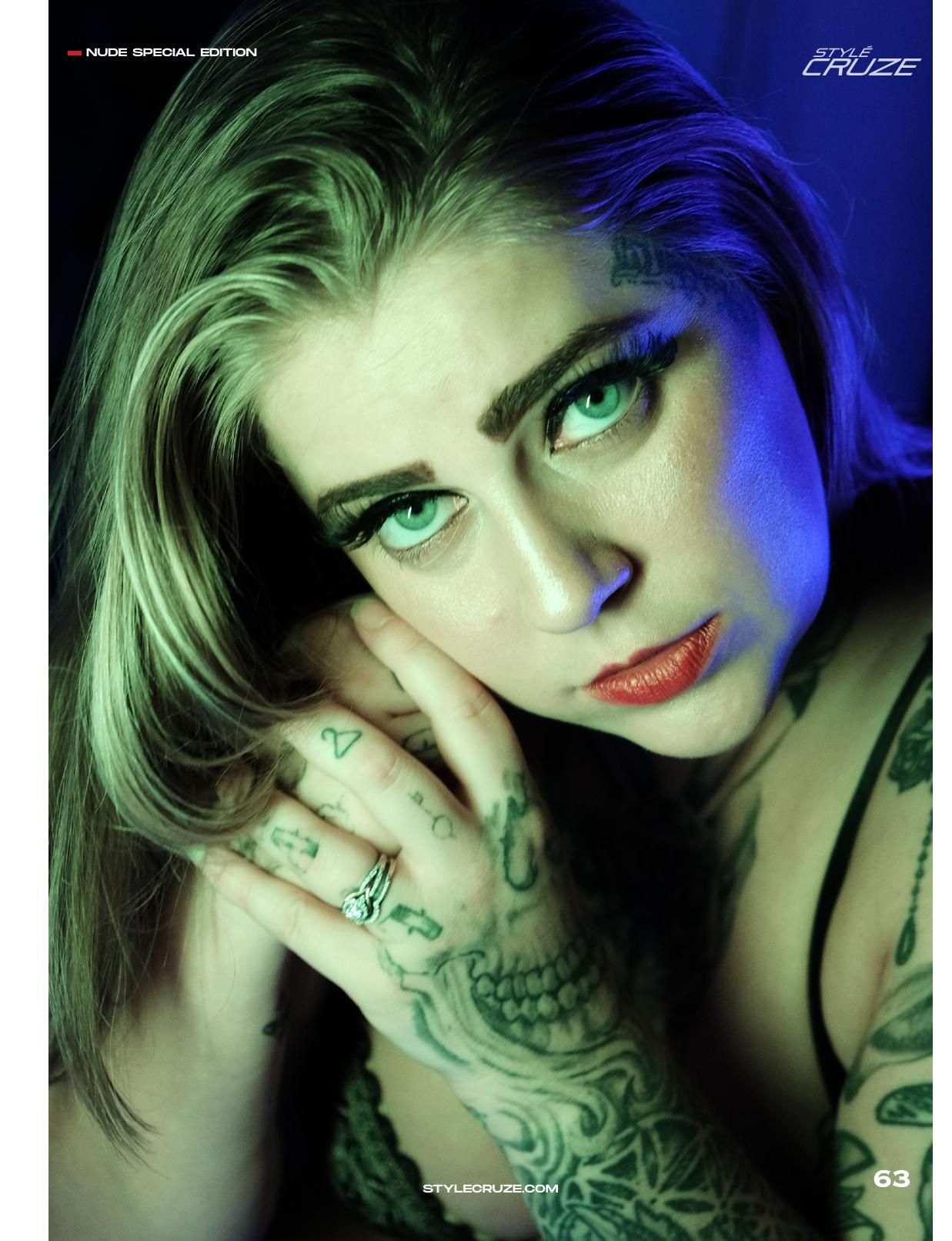 Close-up beauty portrait with dramatic split lighting in green and blue tones.