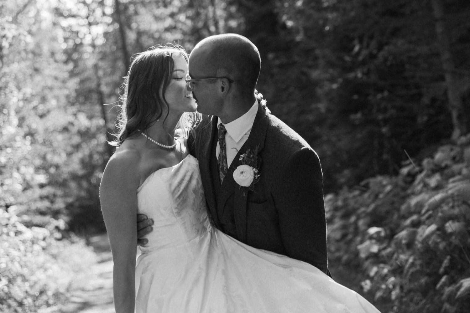 A black and white photo collage of romantic wedding moments captured in an outdoor garden setting.