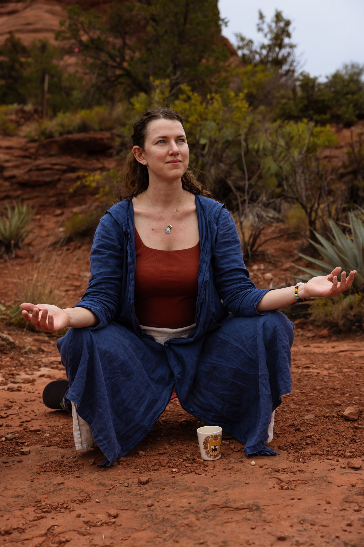 Women meditating at Bell Rock in Sedona, Arizona.