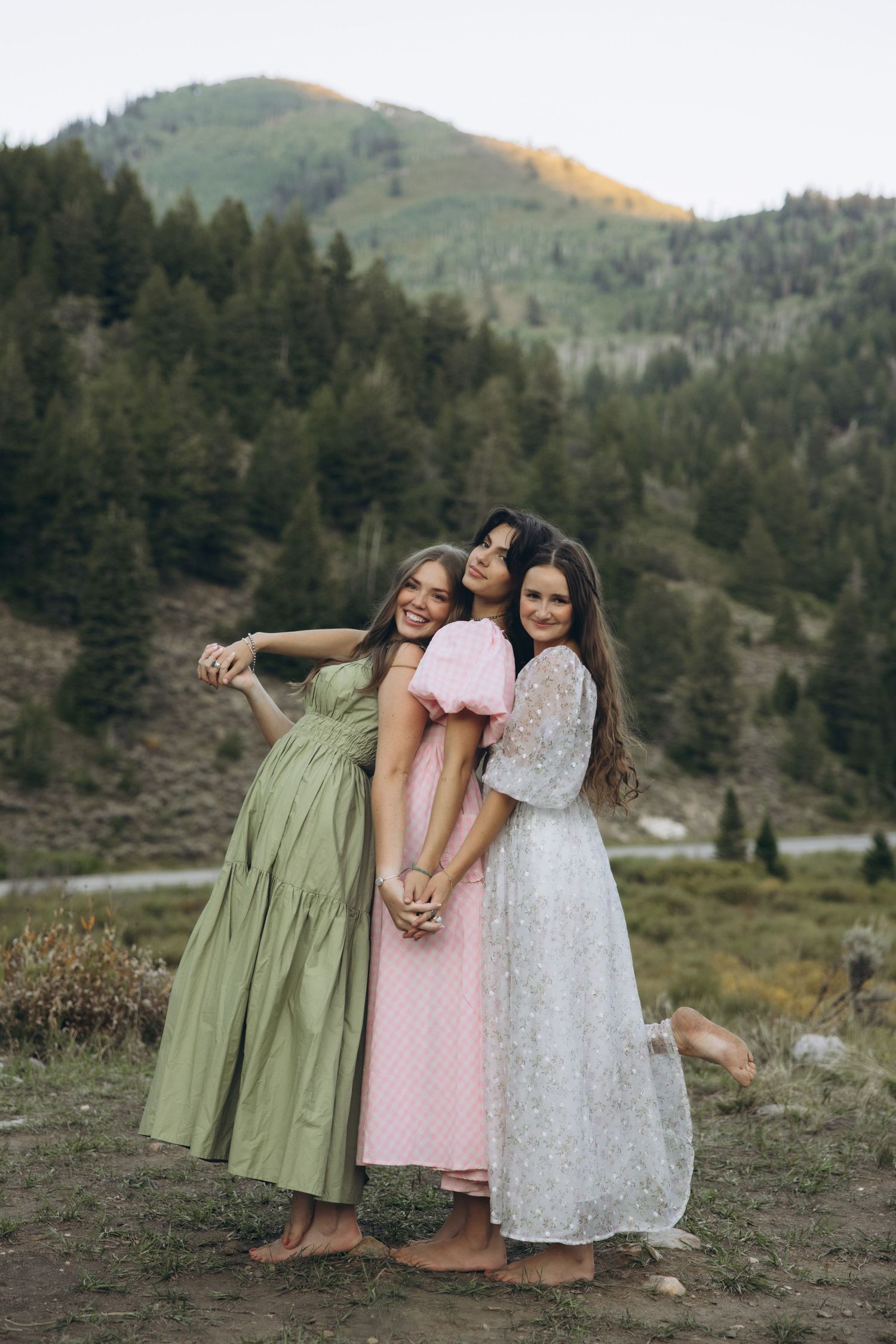 Three women embracing in each other in the Utah mountains. This is sisterhood.