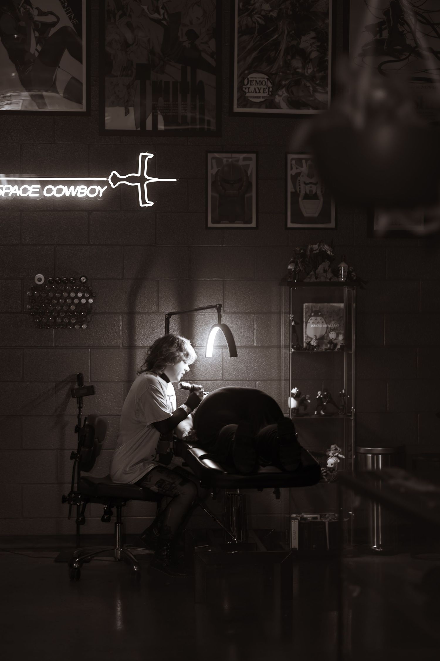 Black and white photo of female tattoo artist.