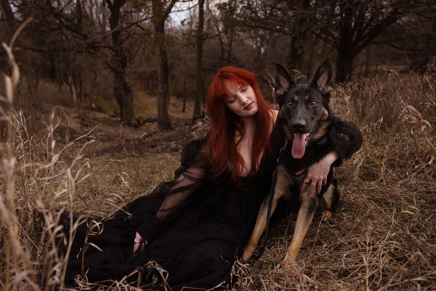 Women with her dog in the midwest prairie grass.