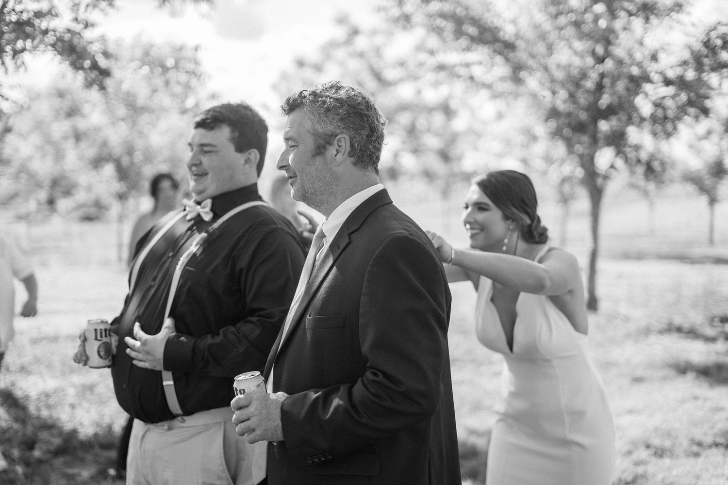 Black and white wedding reaction photos showing emotional guests expressing joy during special moment at ceremony.