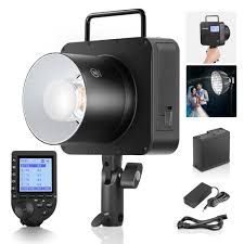 Professional photography studio lighting equipment kit with lights, reflectors, stands, and wireless triggers on white background.