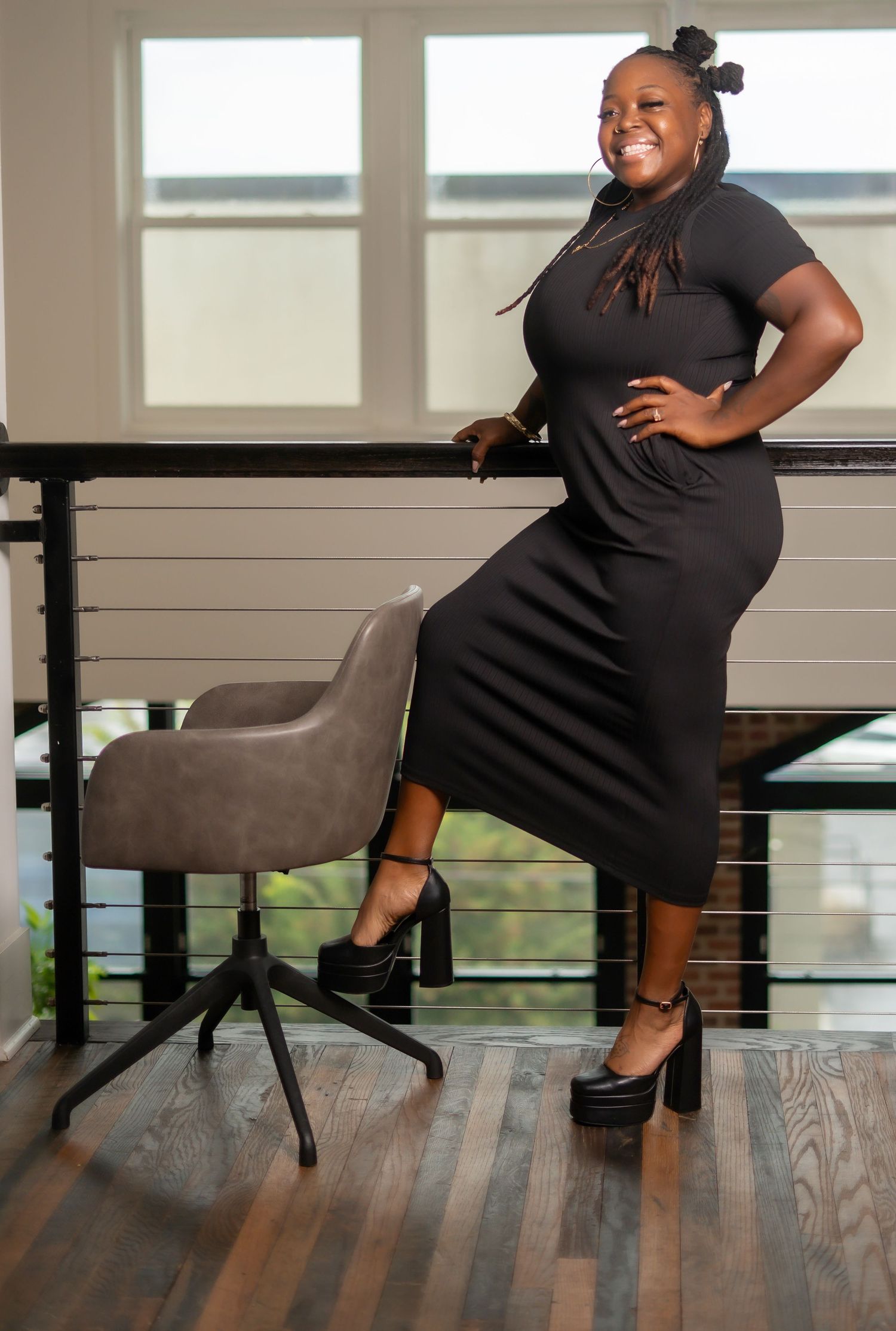 A collage shows a person in a black dress and heels sitting in different poses on a modern chair against hardwood flooring.
