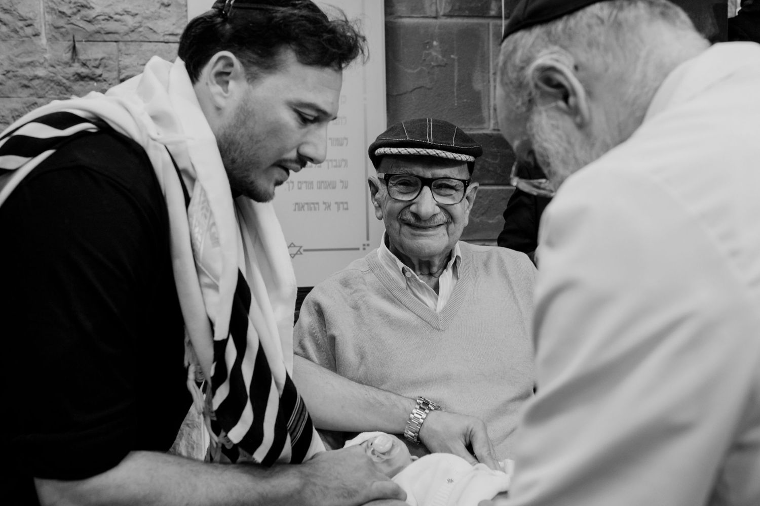 Three men in conversation at formal gathering shown in vintage black and white style.