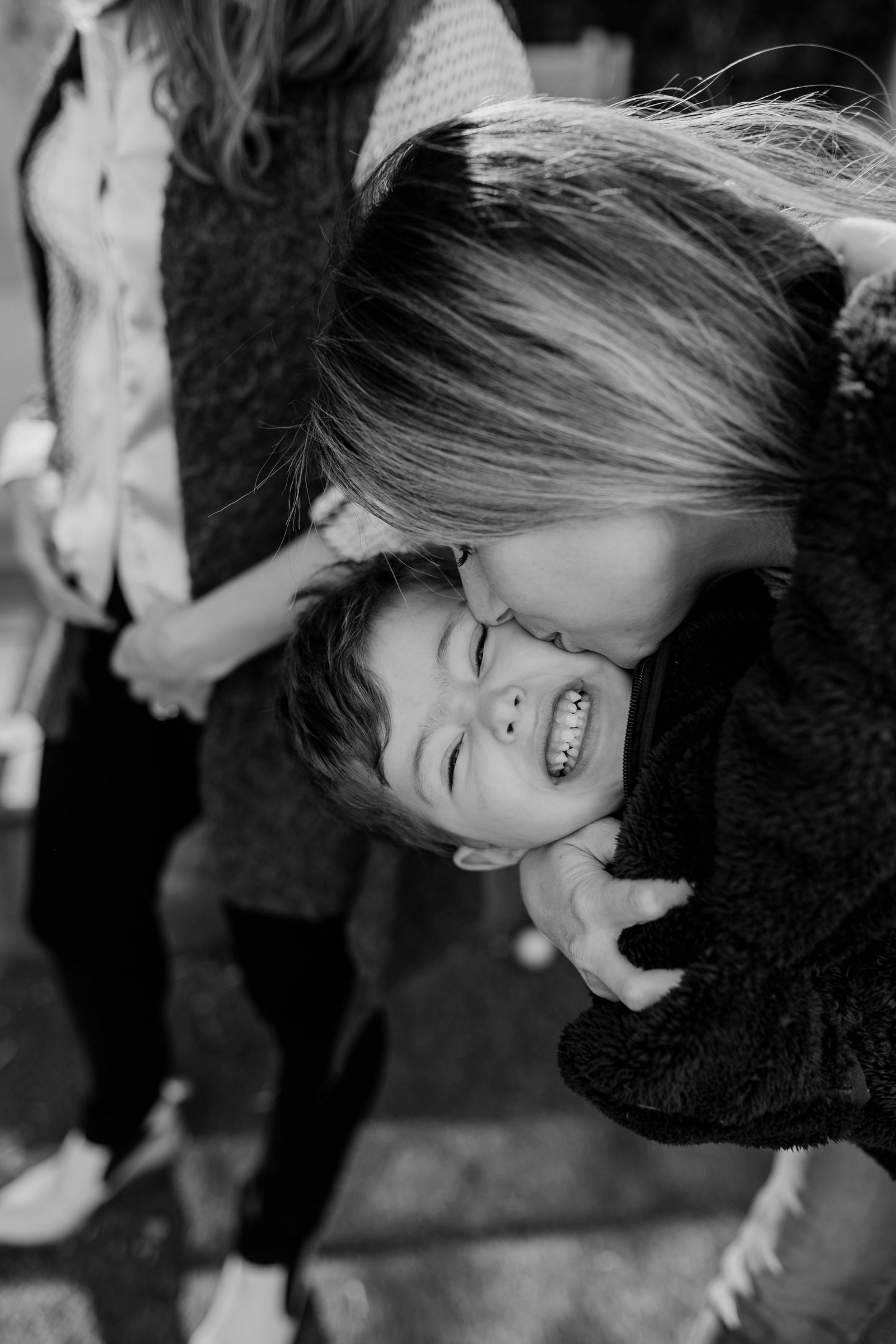 A candid black and white moment of shared laughter and joy.