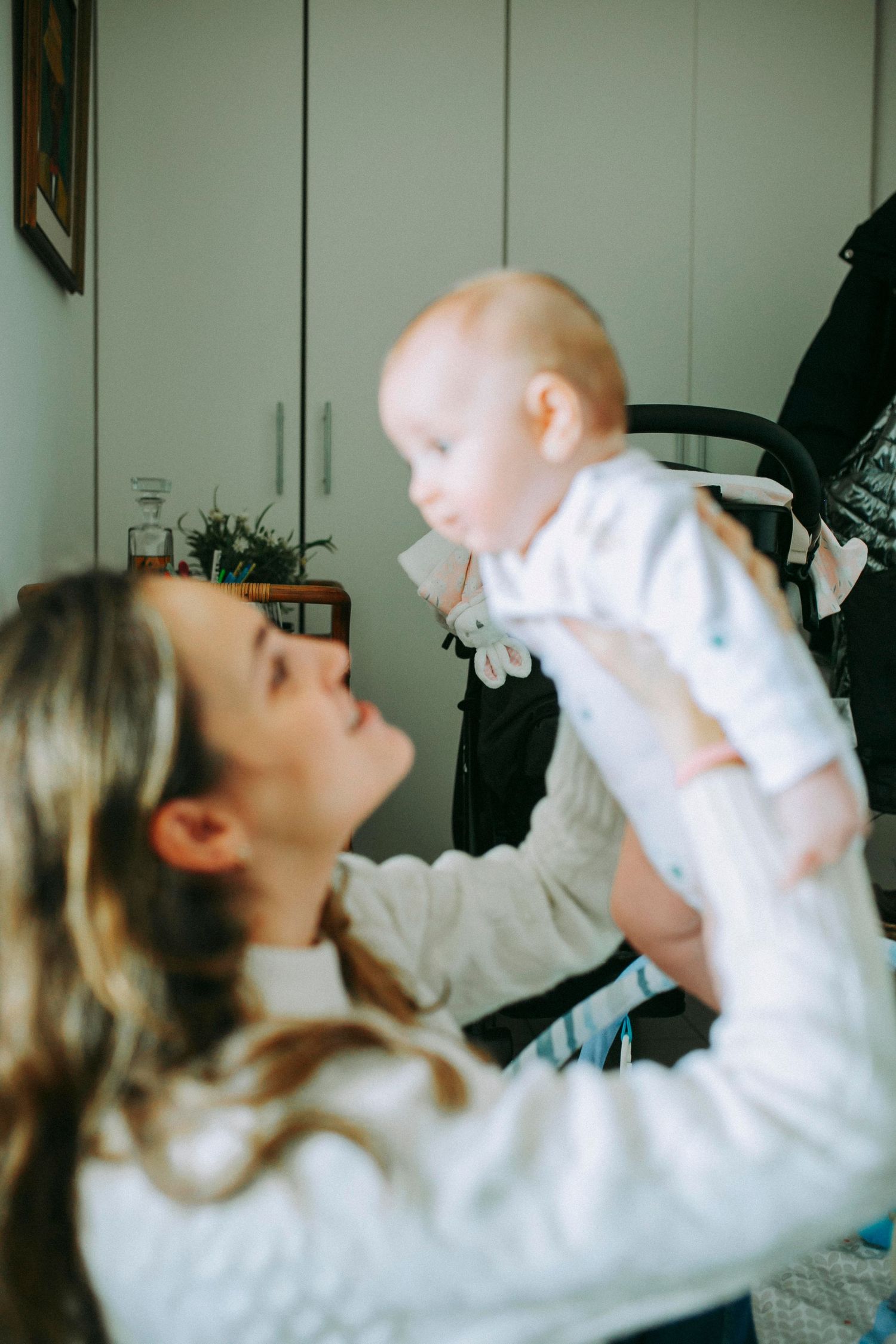 A tender moment between parent and baby as they play together indoors.