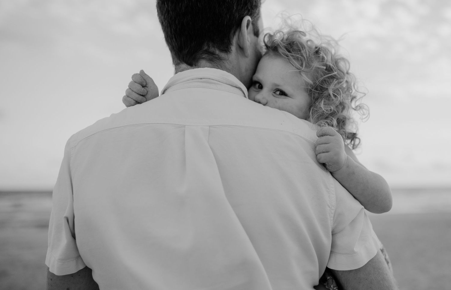 An intimate black and white portrait capturing a tender embrace.