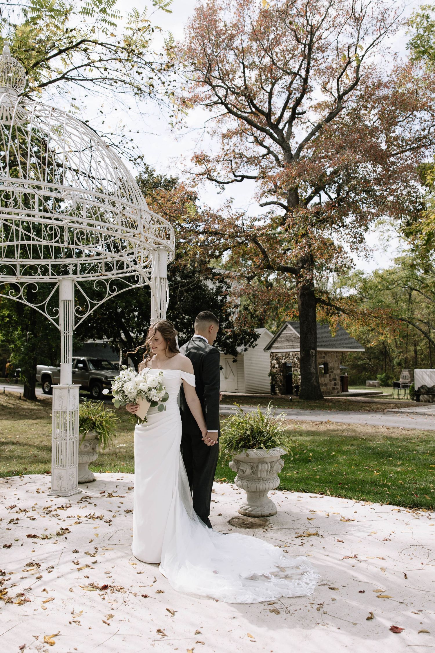 Emotional reactions during wedding ceremony under a decorative white gazebo.