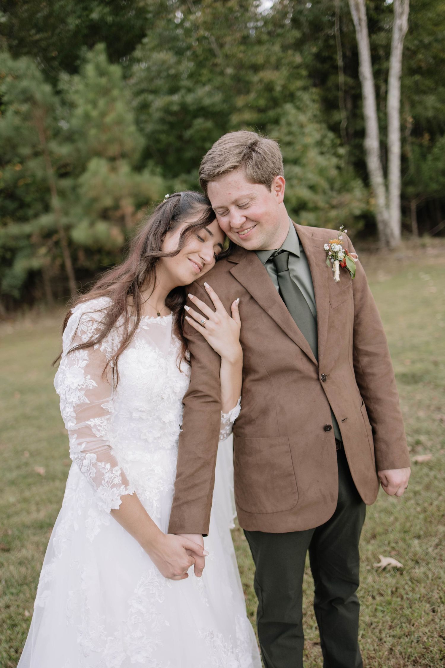 Newlyweds share intimate moments in outdoor wedding portraits.