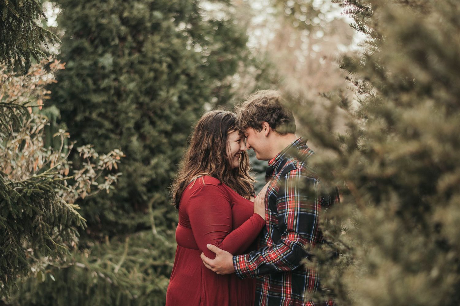 An intimate moment captured between two people in autumn outdoor setting.