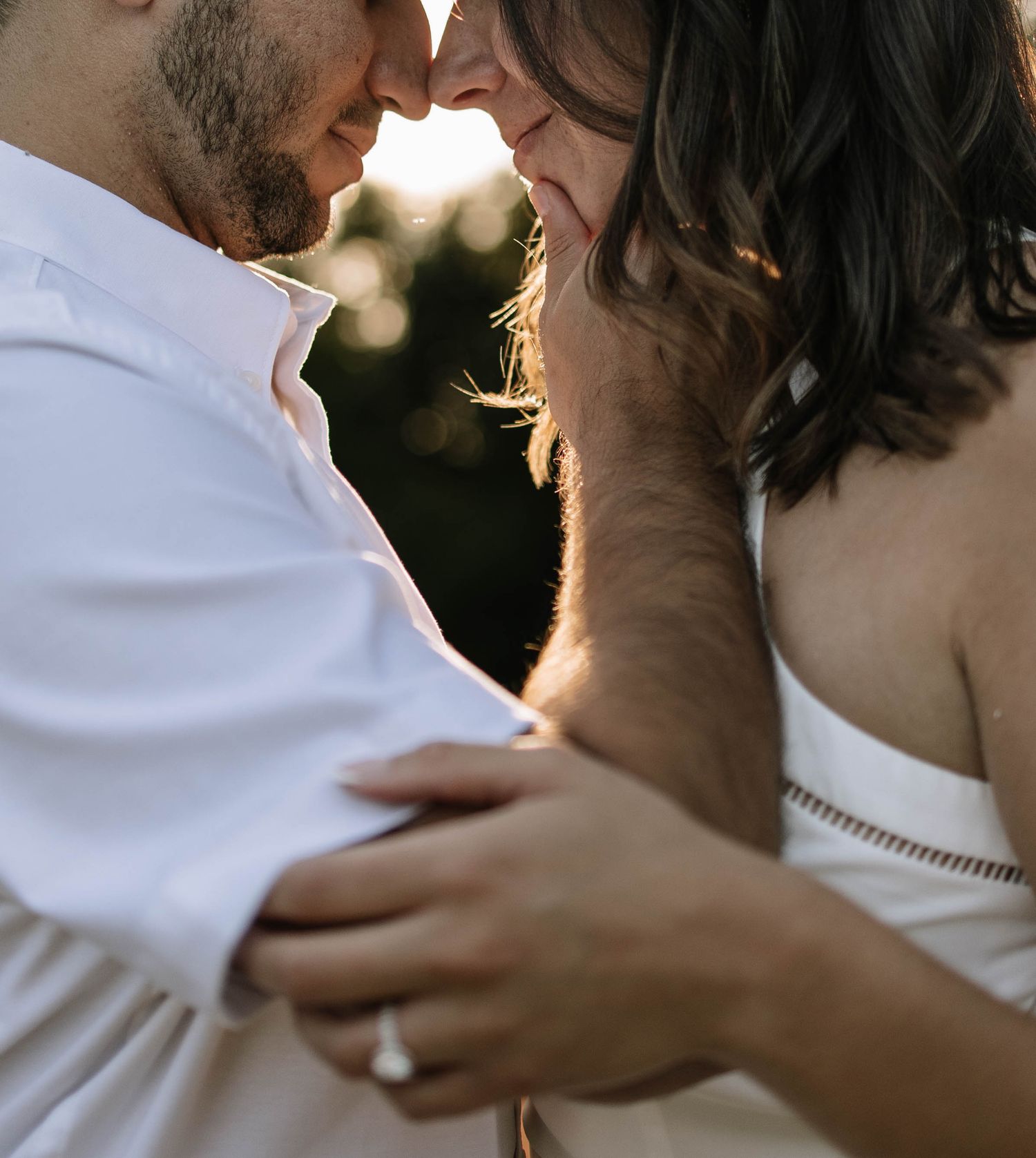 Intimate close-up shots of a couple embracing outdoors during a photo session.