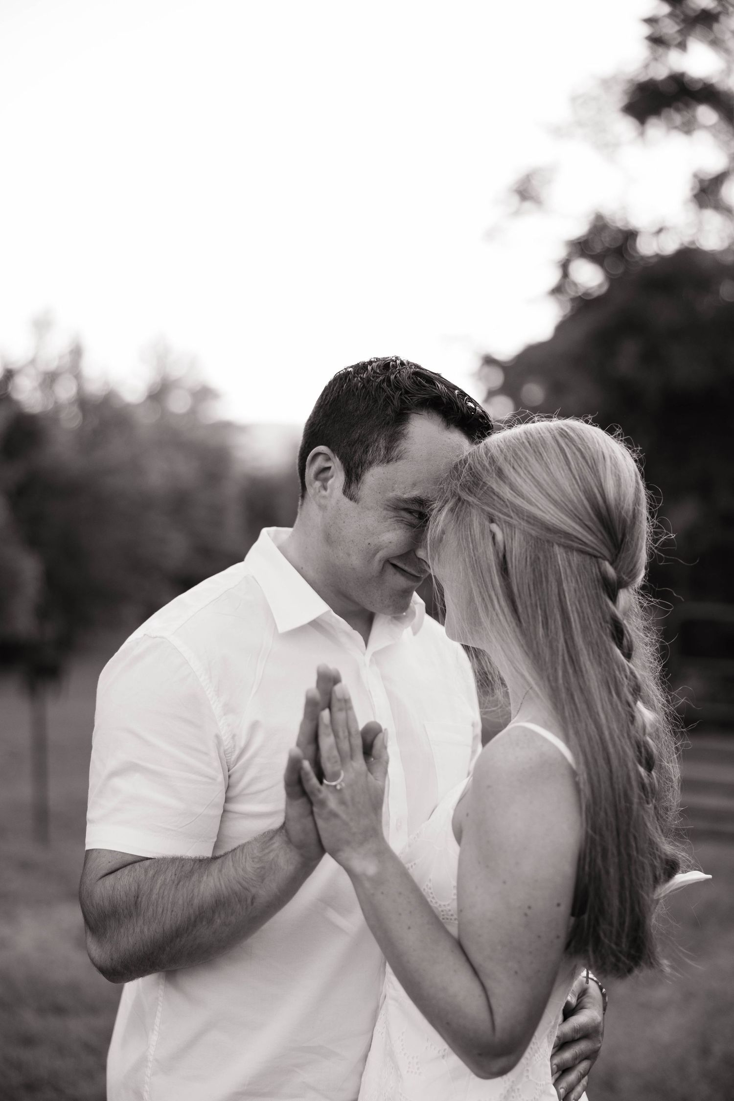 Black and white photo series of a couple sharing joyful moments outdoors.