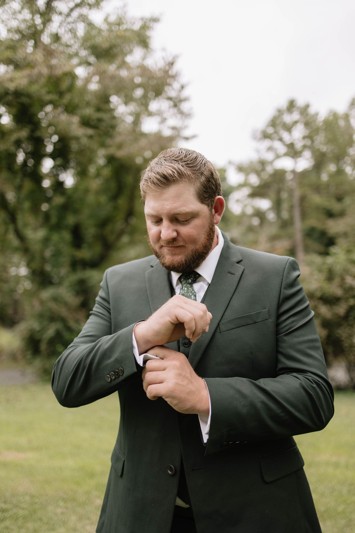 Groom in dark suit adjusts his tie in a sequence of candid outdoor wedding photos.