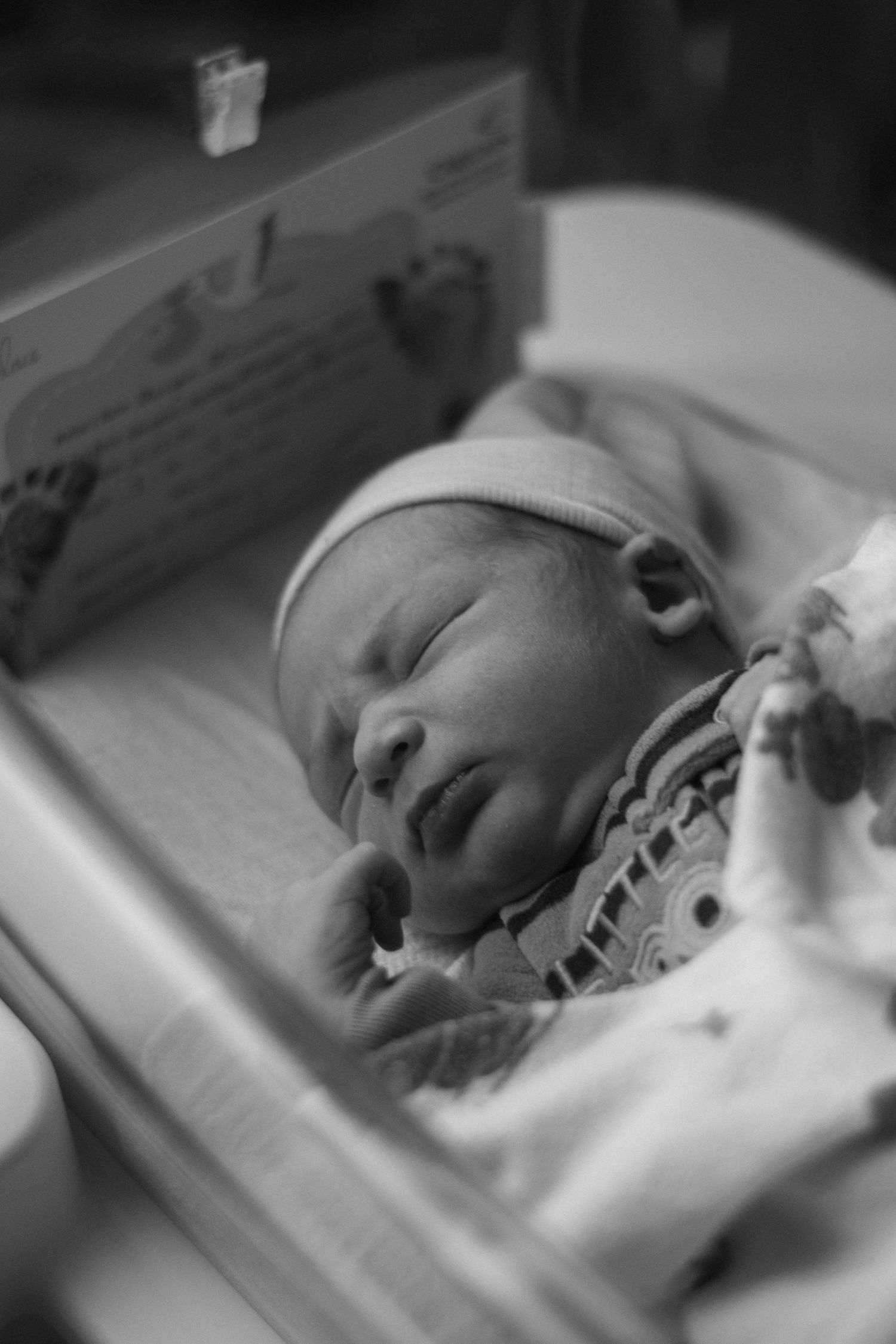 Peaceful sleeping newborn in black and white photography series.