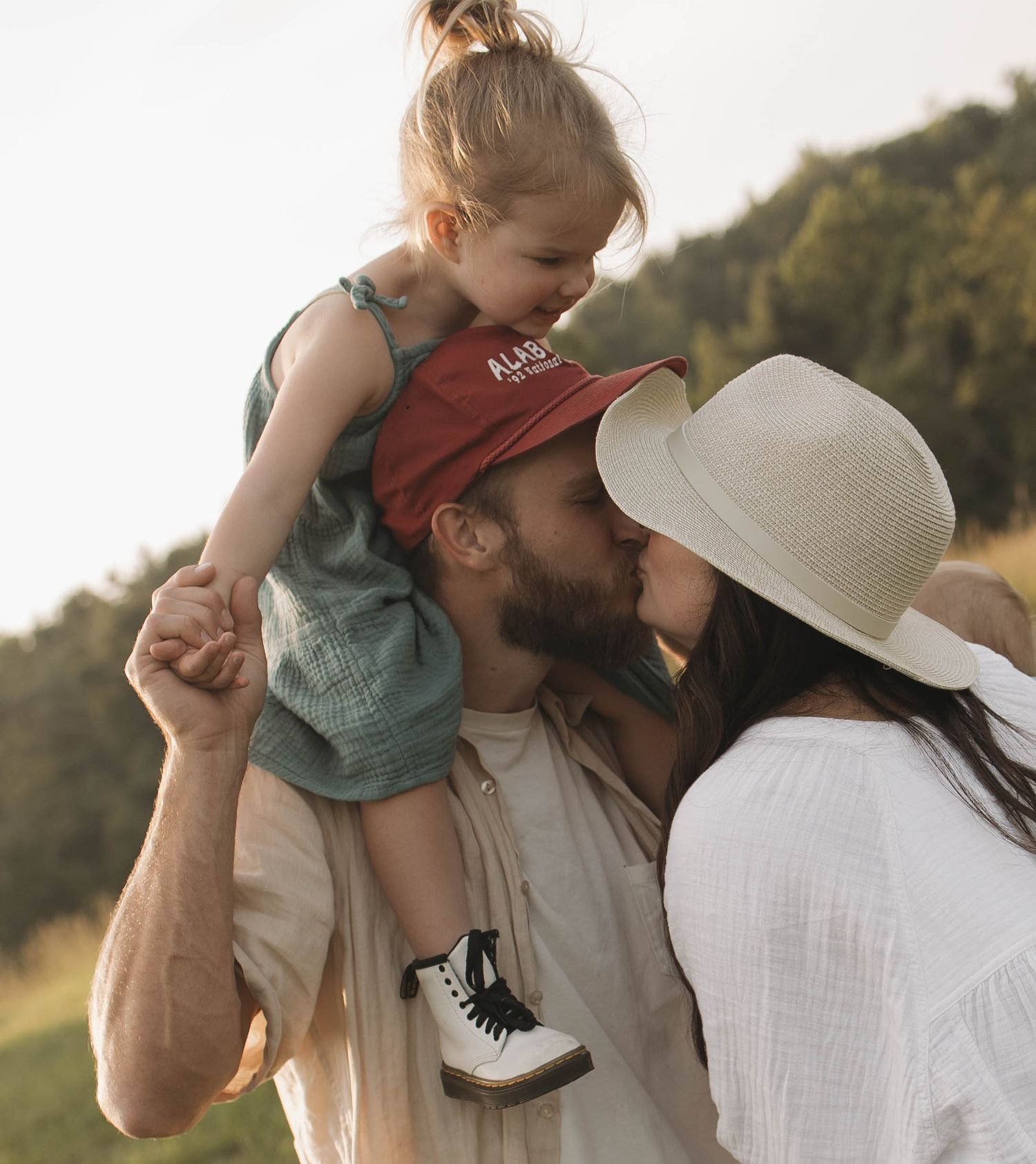 A sweet family moment captured at sunset with casual outdoor styling.