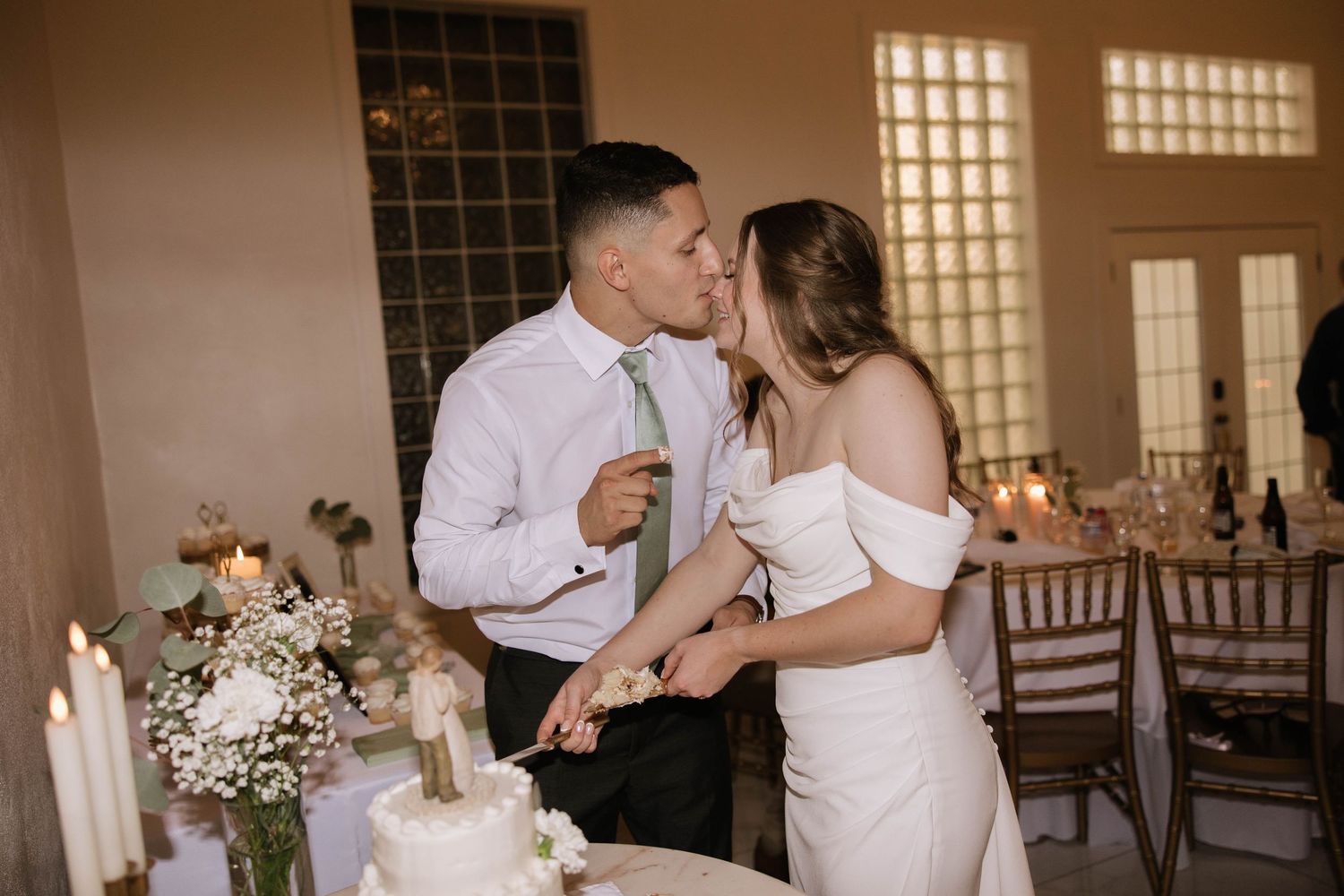 A couple shares their first dance at their wedding reception in a beautifully lit venue.
