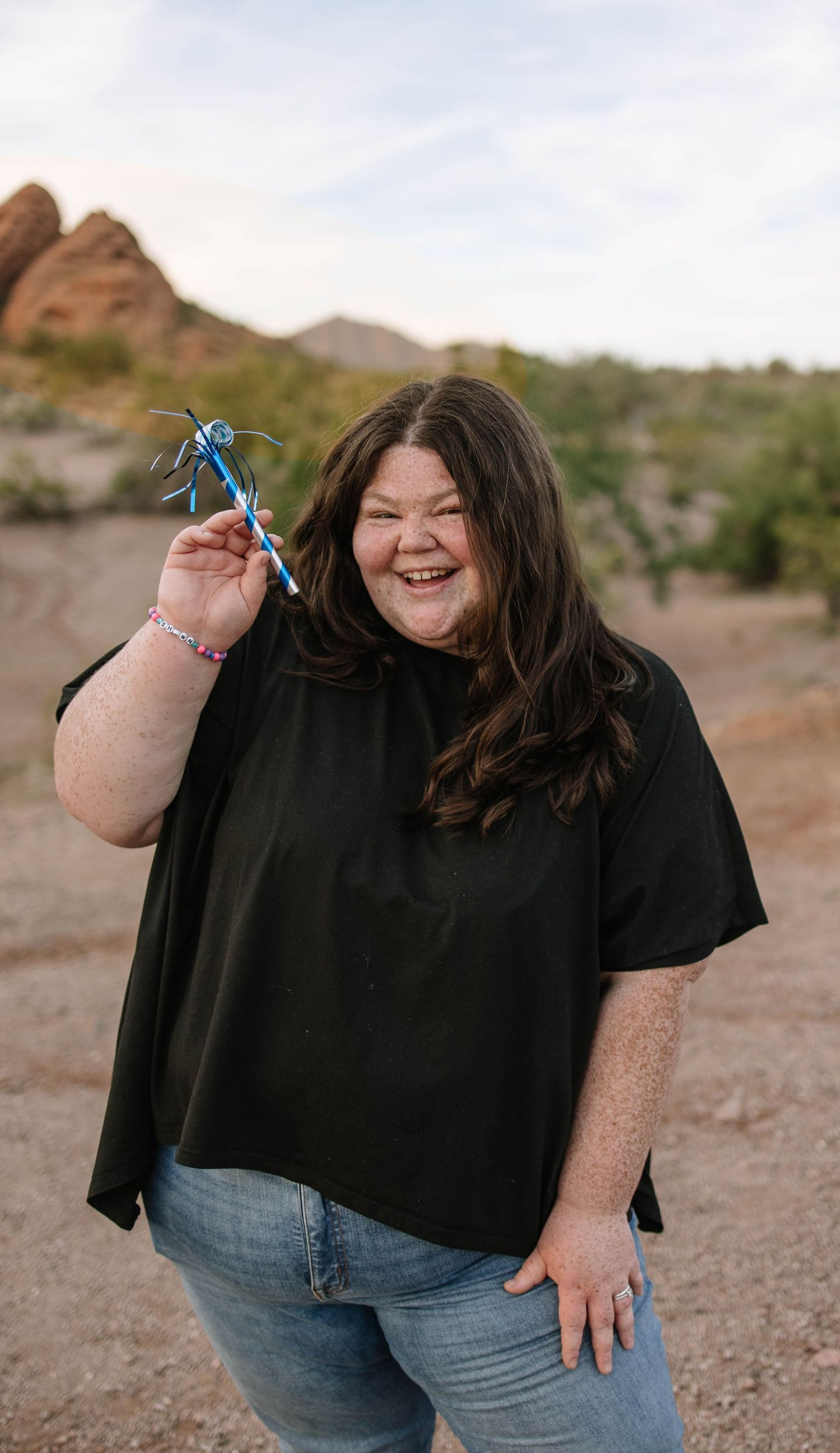 A series of candid outdoor portrait shots showing joyful expressions against a desert mountain backdrop.