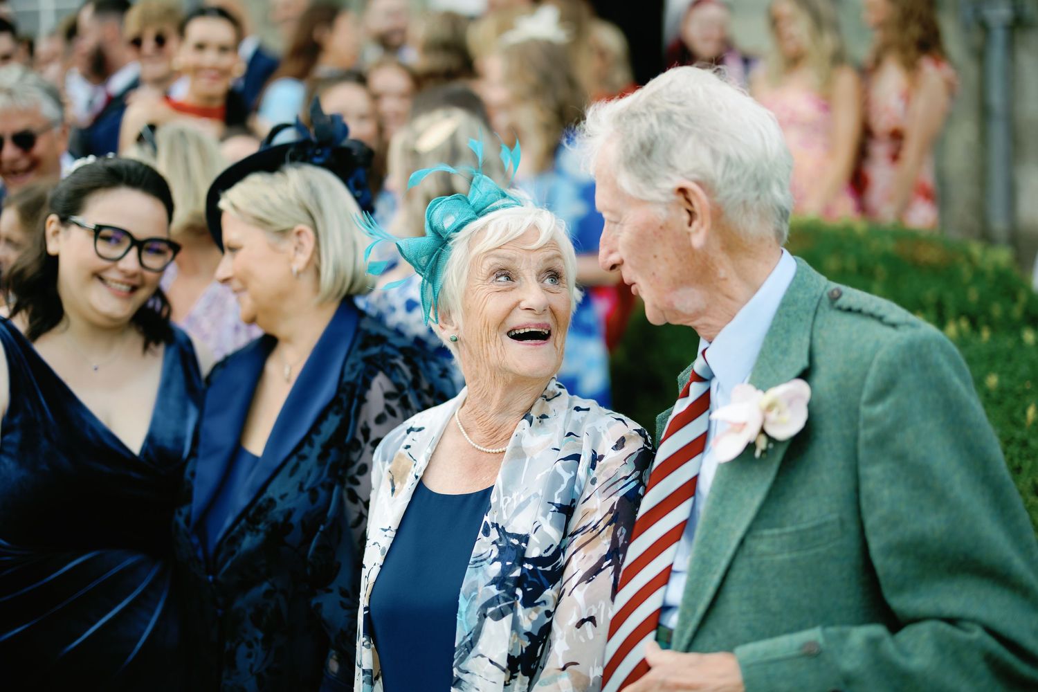 A collage of people enjoying themselves at a formal outdoor event with laughter and smiles.