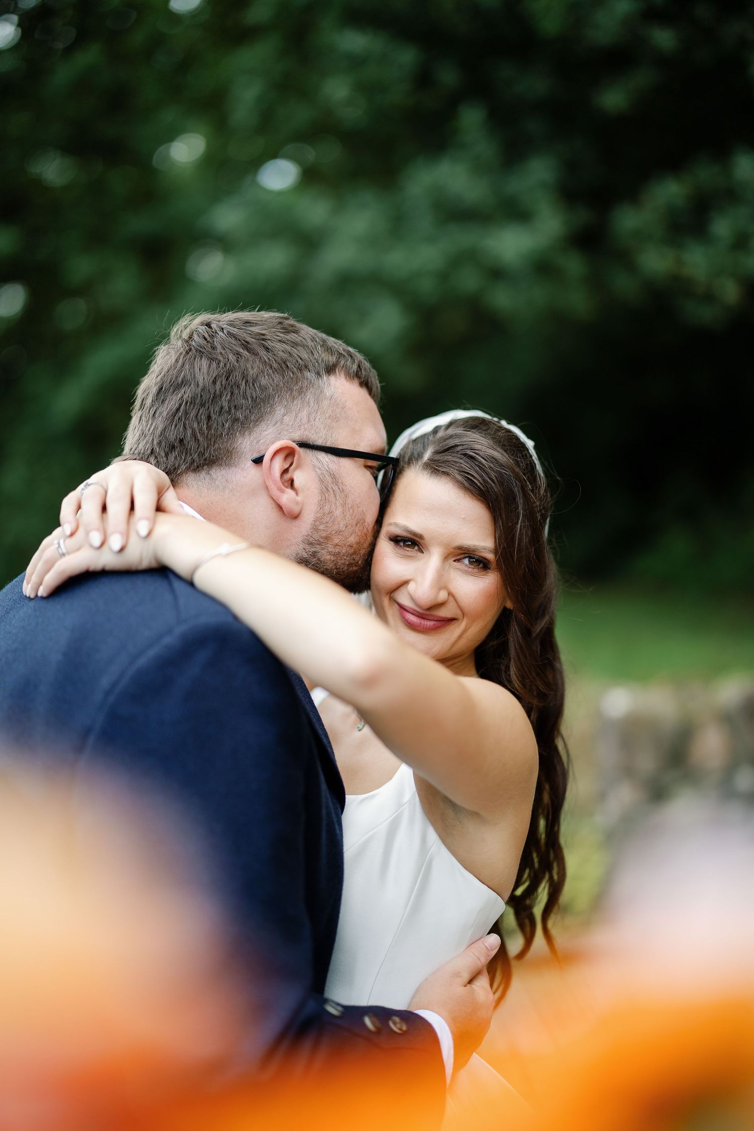 “Newlyweds walking through the gardens of Kinmount House in Scotland, surrounded by natural greenery and timeless architecture.”