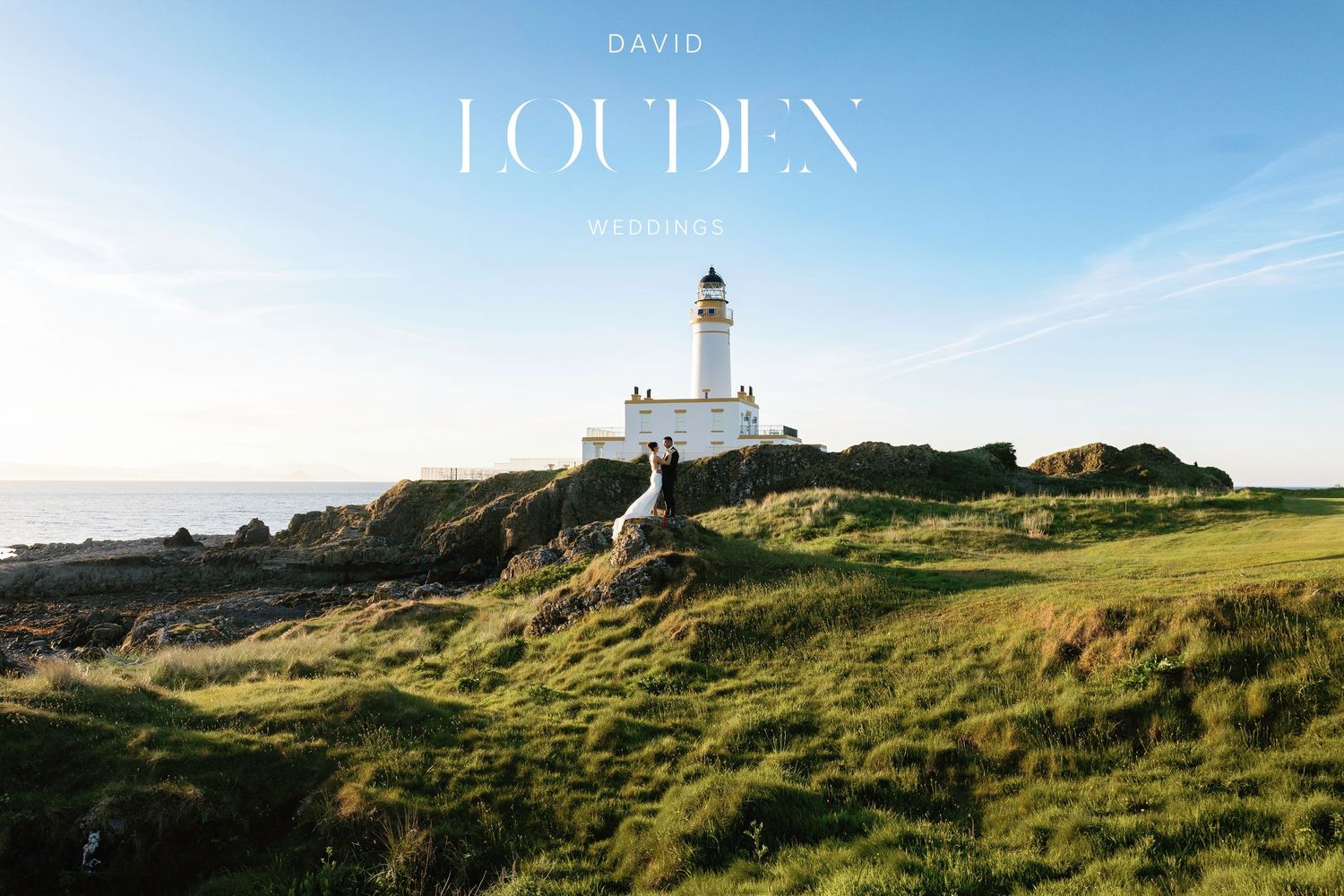 Historic lighthouse perched on grassy cliff overlooking ocean with dramatic sky Trump Turnberry Wedding
