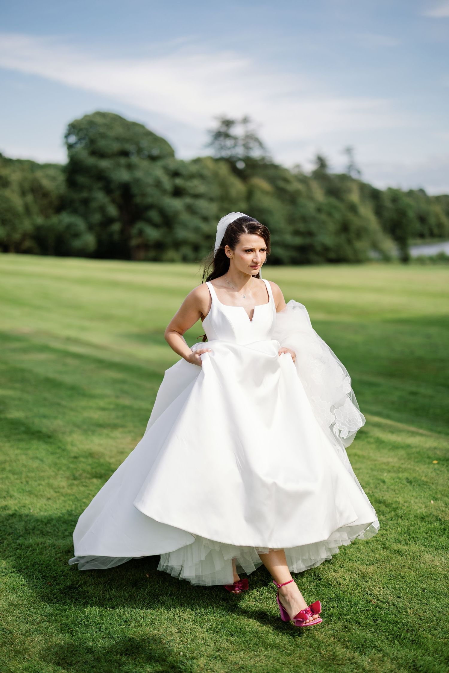 “Newlyweds walking through the gardens of Kinmount House in Scotland, surrounded by natural greenery and timeless architecture.”