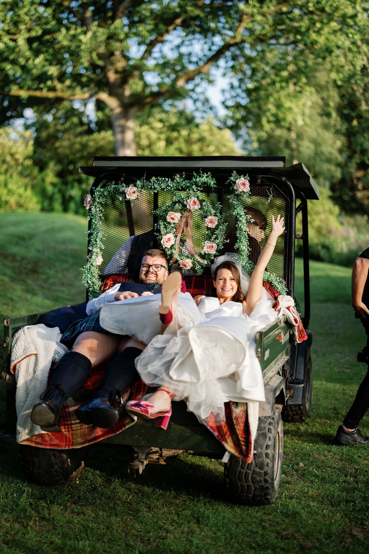 “Bride and groom standing in front of Kinmount House, a stately Scottish mansion with sweeping lawns and classic architecture.”