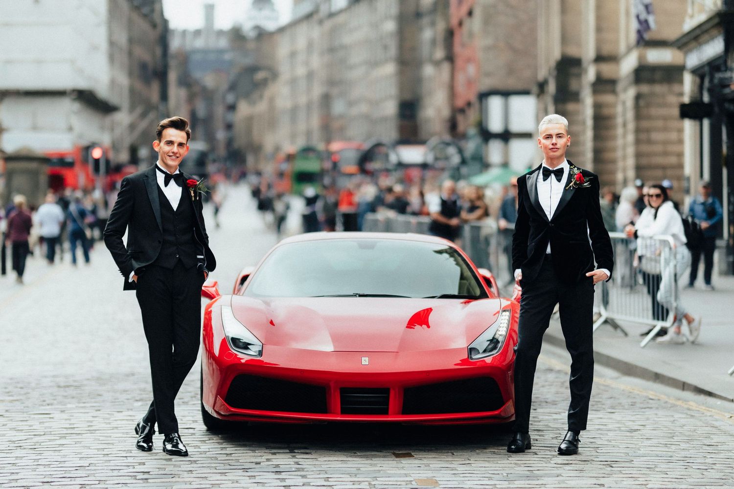 wedding with Red Ferrari parked on a cobblestone street in front of historic architecture in Edinburgh Royal Mile