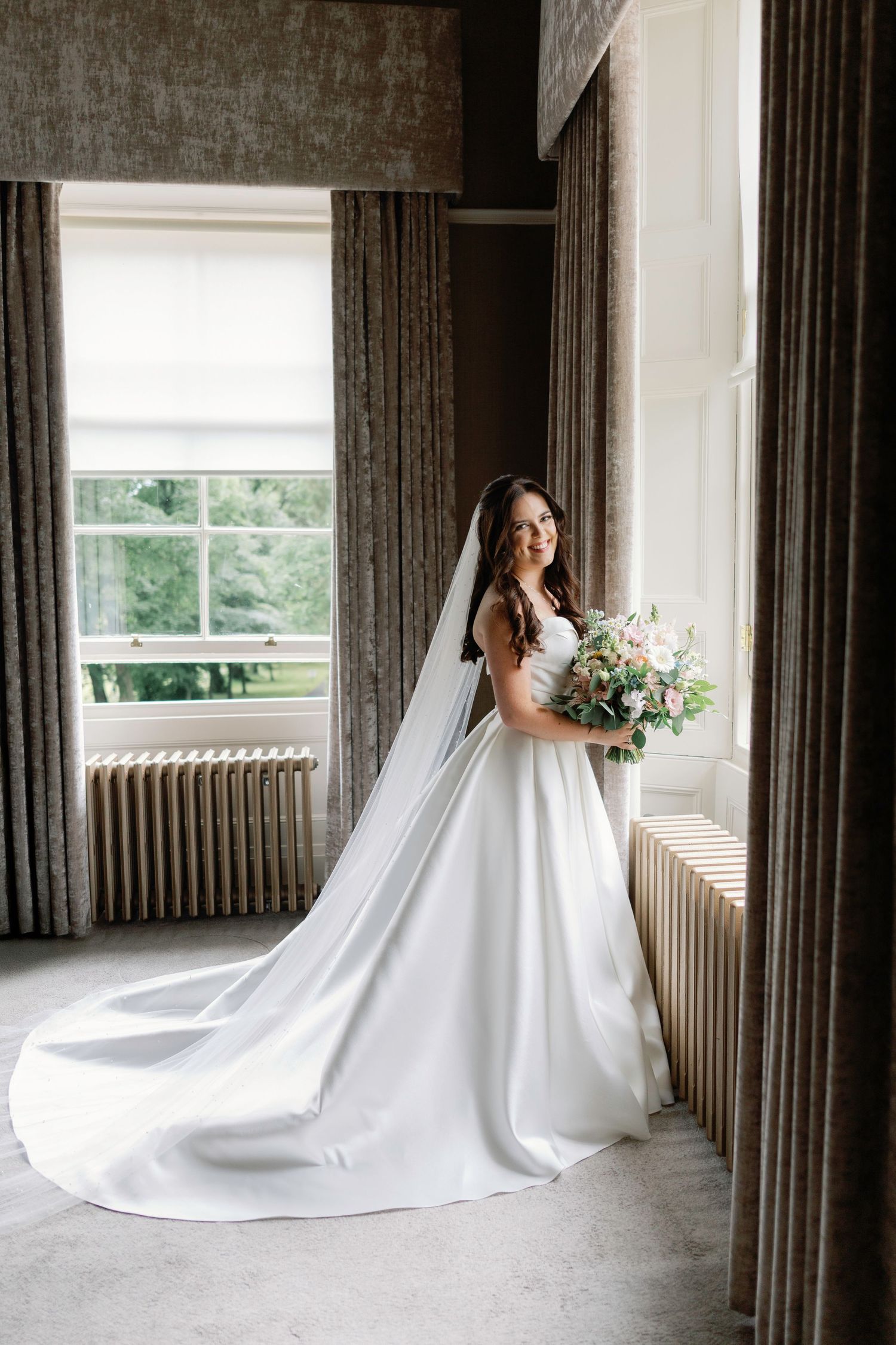Classic bridal portrait with flowing train and bouquet in room with gray curtains Carlowrie Castle Wedding